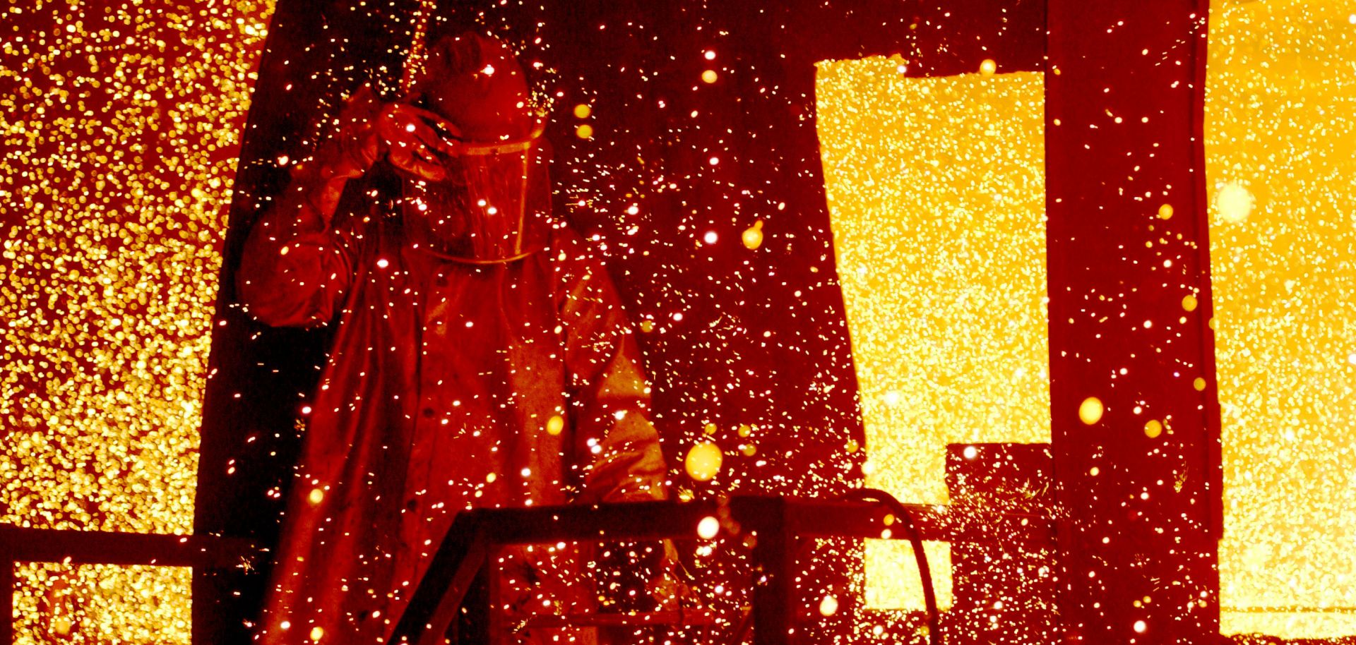 A cloud of molten steel envelopes a worker at a TAMCO Steel, Inc. mill in Rancho Cucamonga, California, in 2002.