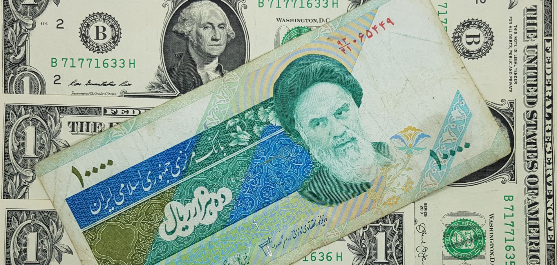 This photo shows 10,000 Iranian rials on top of U.S. dollars.