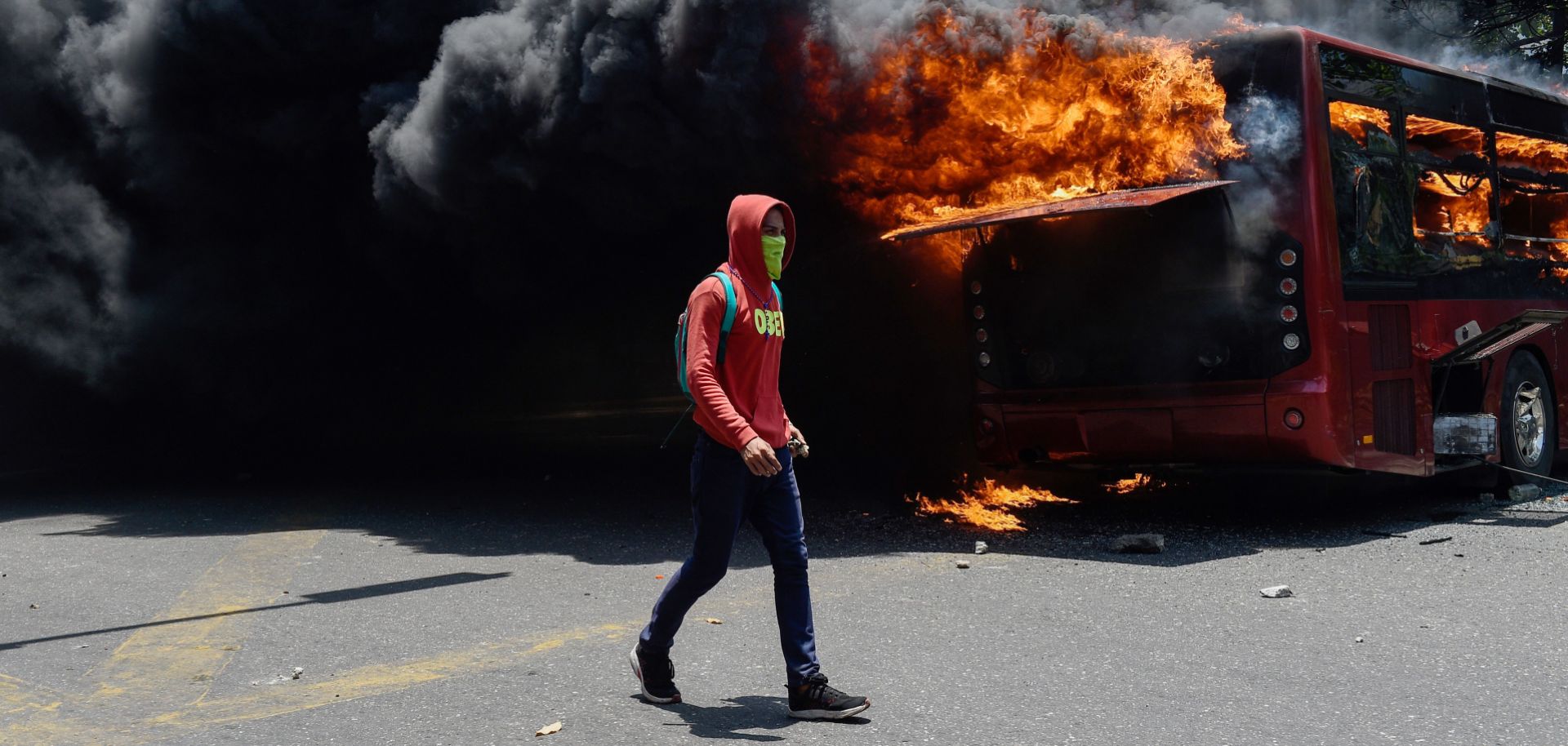 A bus burns near La Carlota military base in Caracas, Venezuela, during clashes between opposition protesters and Venezuelan soldiers on April 30, 2019.