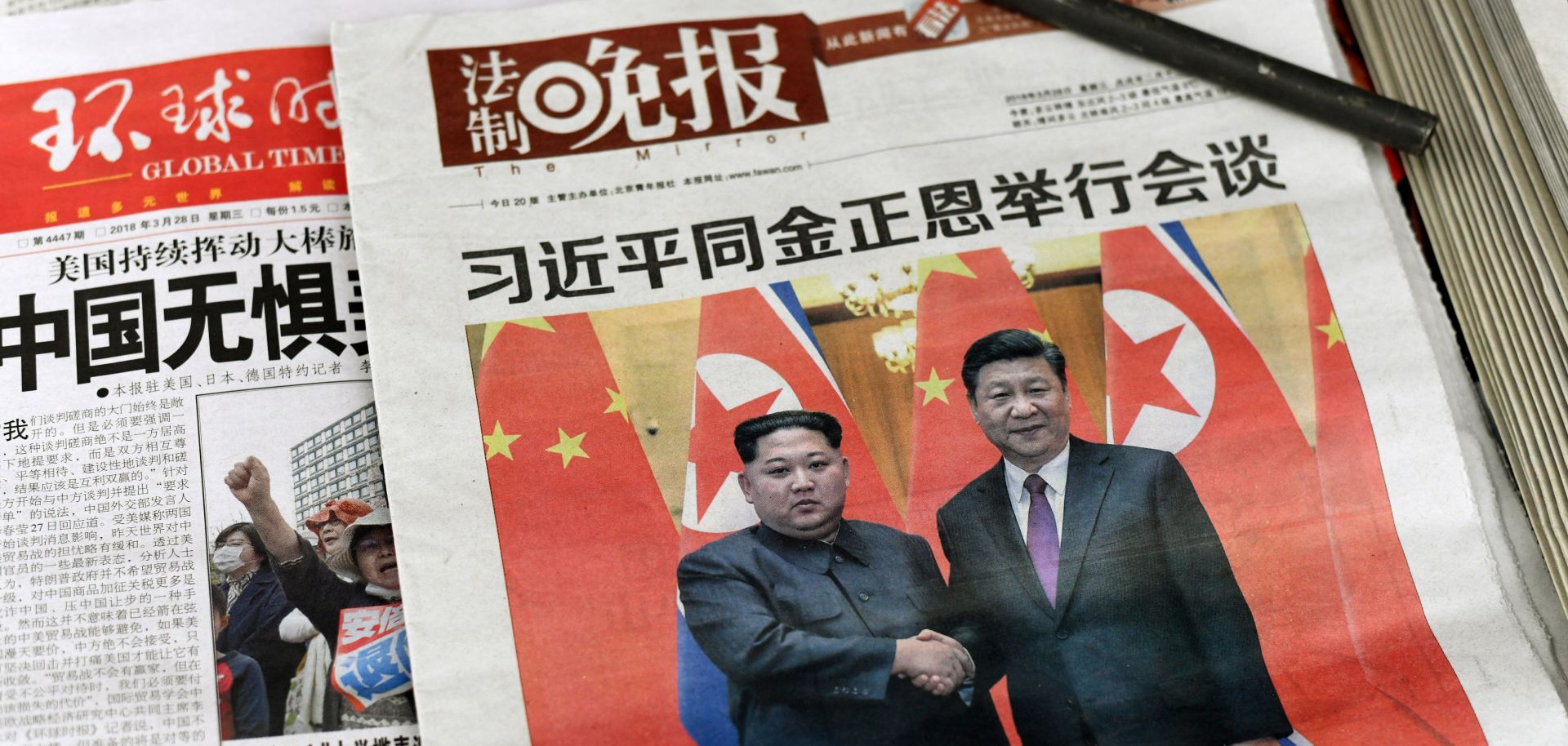 The front page of a March 28, 2018, newspaper in Beijing shows Chinese President Xi Jinping with North Korean leader Kim Jong Un.