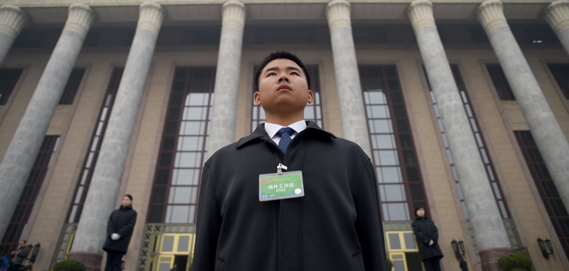 A security guard stands in front of the Great Hall of the People as delegates arrive for a conference in Beijing on March 4, 2016.