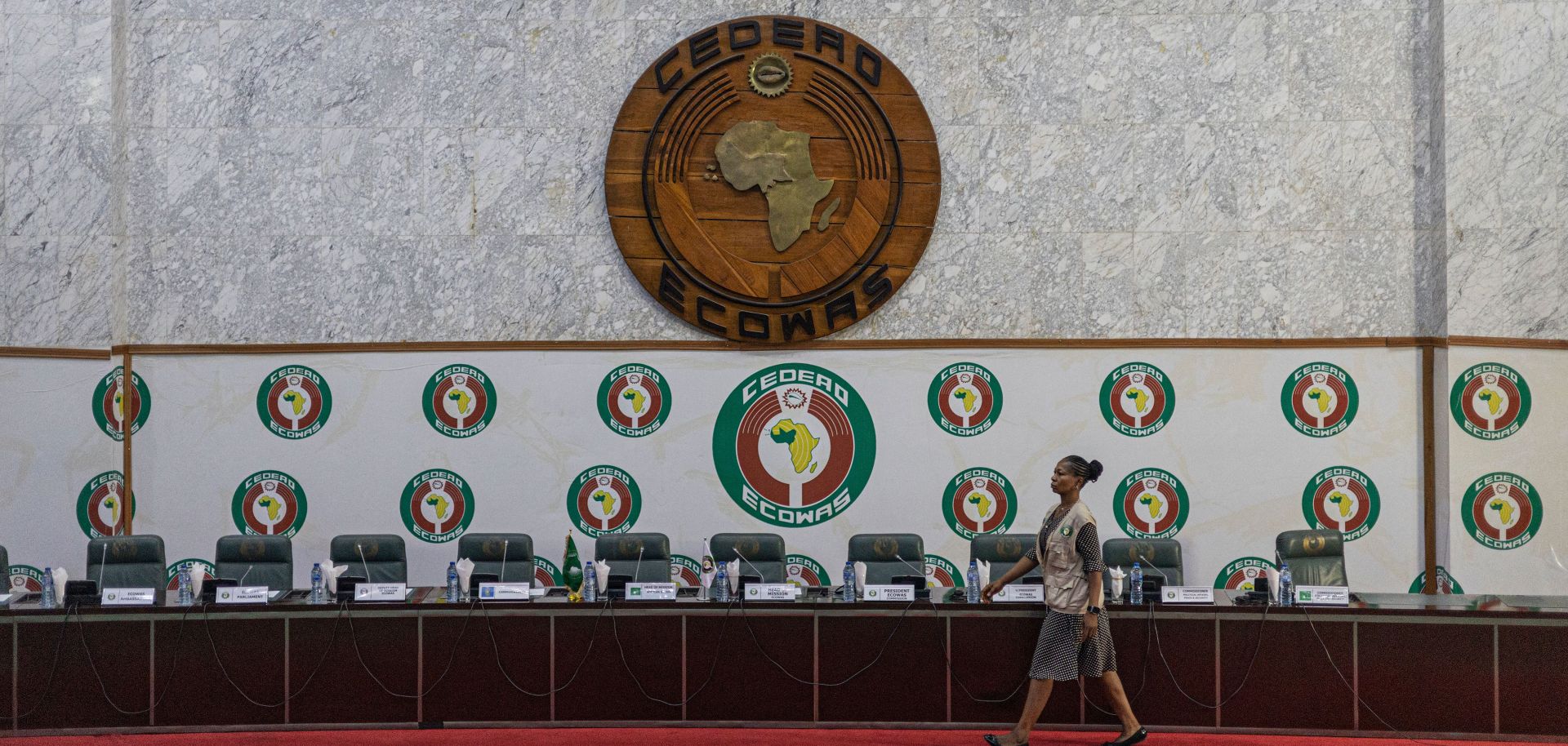 A staff member walks past a stage before a press conference at the Economic Community of West African States (ECOWAS) headquarters in Abuja, Nigeria, on Feb. 27, 2023. 