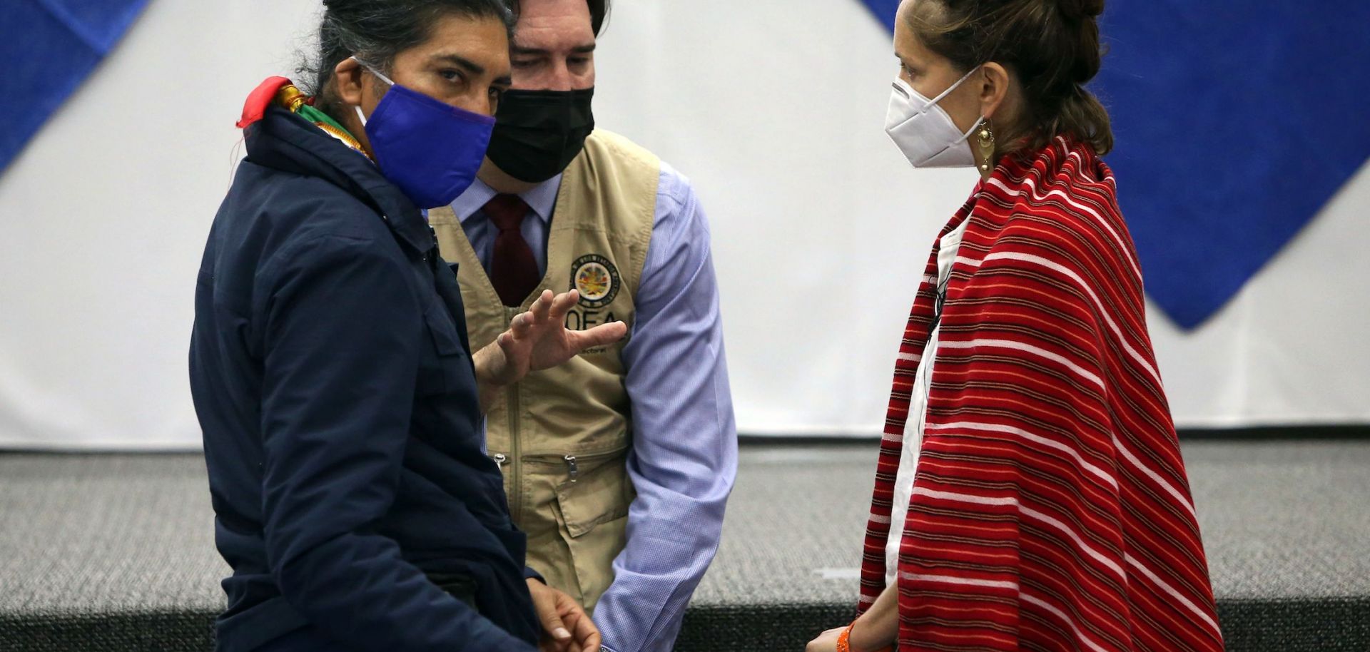 Ecuadorean presidential candidate Yaku Perez (L) and his partner French-Brazilian Manuela Picq (R) speak with an OAS member during a meeting with his competitor Guillermo Lasso