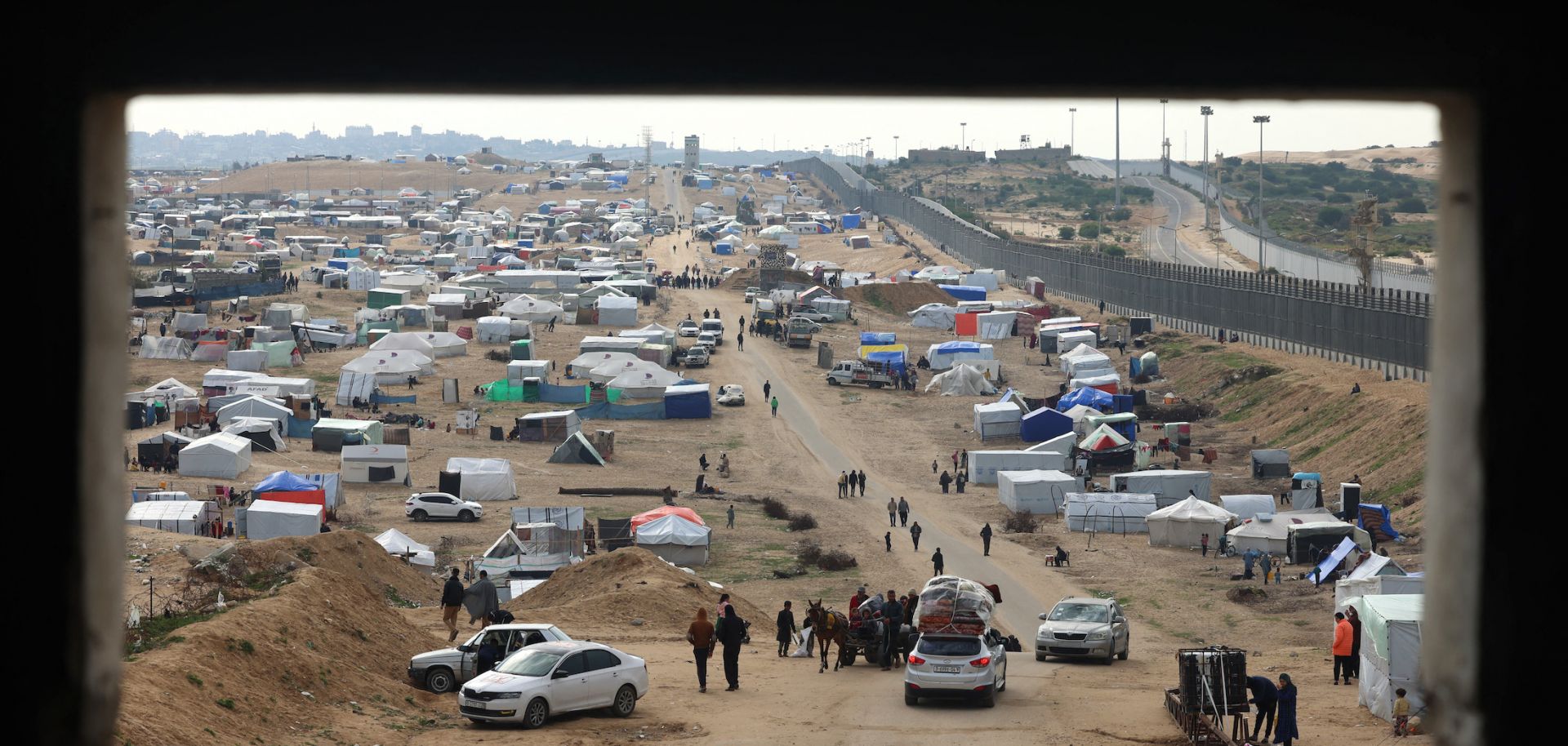 Displaced Palestinians camp near the fence separating the Gaza Strip from Egypt on Feb. 16, 2024, in the southern Gaza city of Rafah.