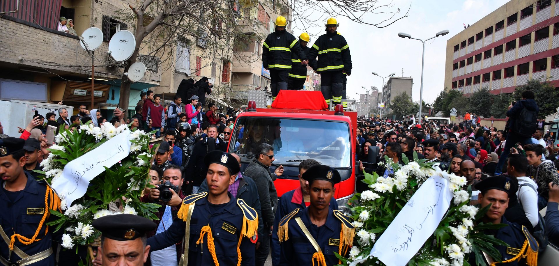 Policemen carry wreaths in Cairo on Feb. 19, 2019, at the funeral of Mahmud Abu el-Yzied, one of three policemen killed in a bombing the previous day.