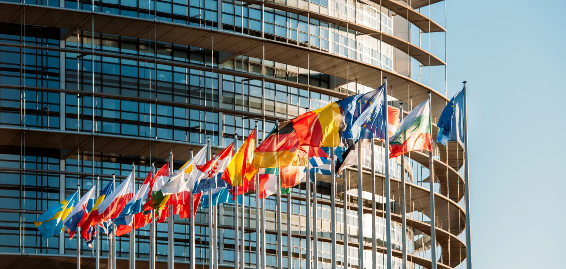 Flags wave in front of the European Parliament building in Strasbourg, France.