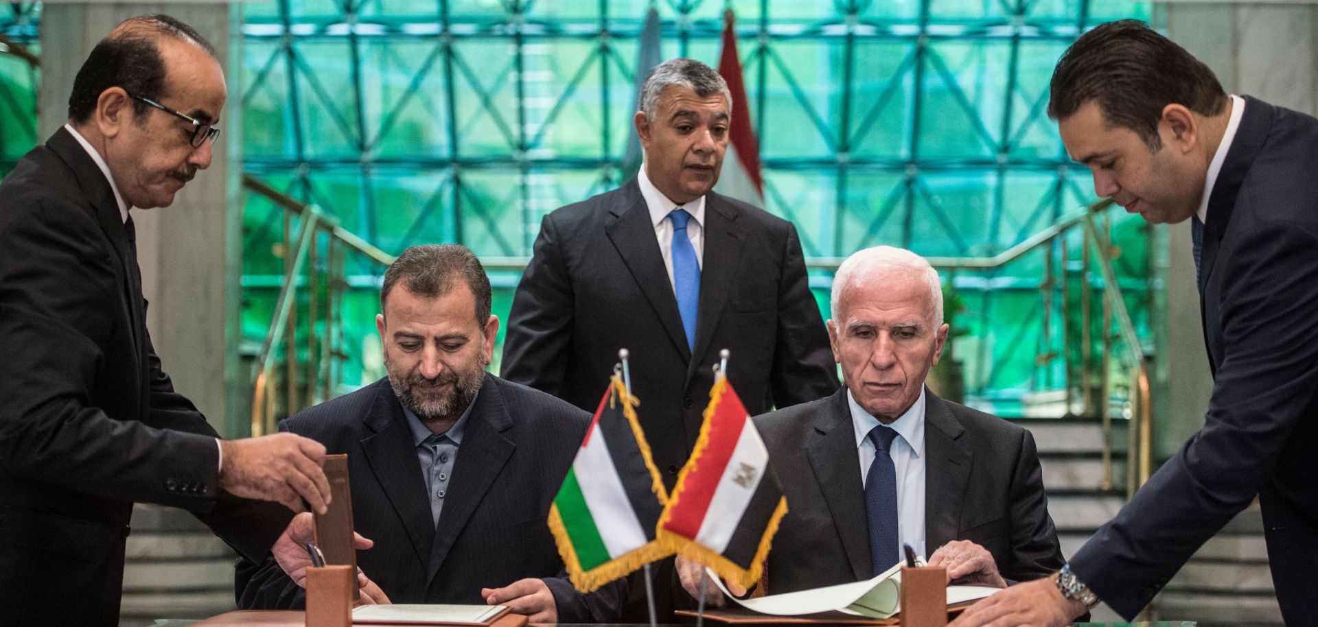 The leaders of Fatah and Hamas sign a reconciliation deal at the Egyptian intelligence services headquarters in Cairo on Oct. 12, ending their decadelong split.
