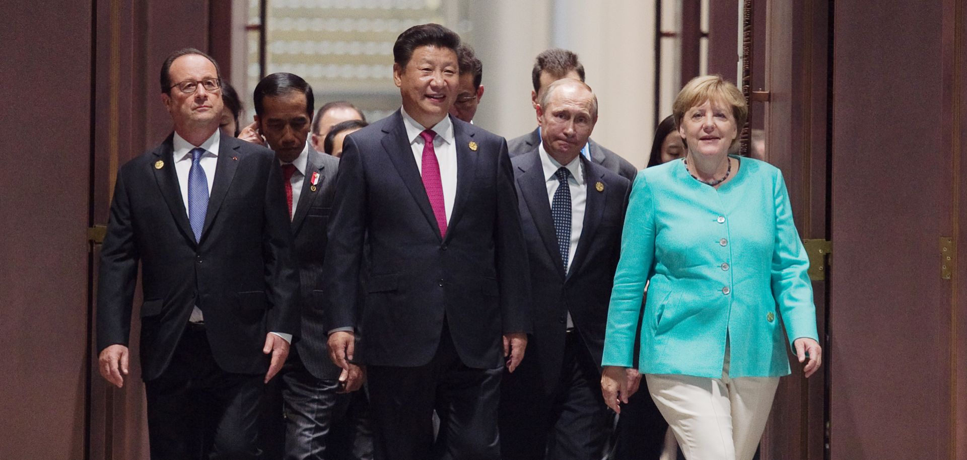 German Chancellor Angela Merkel walks with Chinese President Xi Jinping and Russian President Vladimir Putin at the 2016 G-20 meeting in Hangzhou, China.