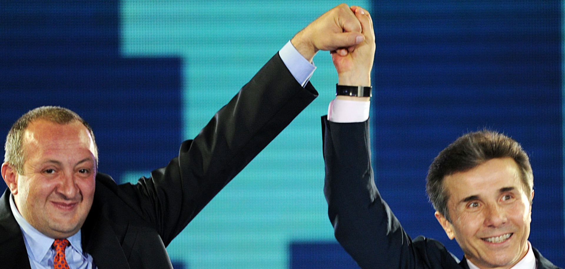 Former Georgian Prime Minister Bidzina Ivanishvili joins hands with Georgian Dream presidential candidate Giorgi Margvelashvili at a political rally in Tbilisi on Sept. 19, 2013.