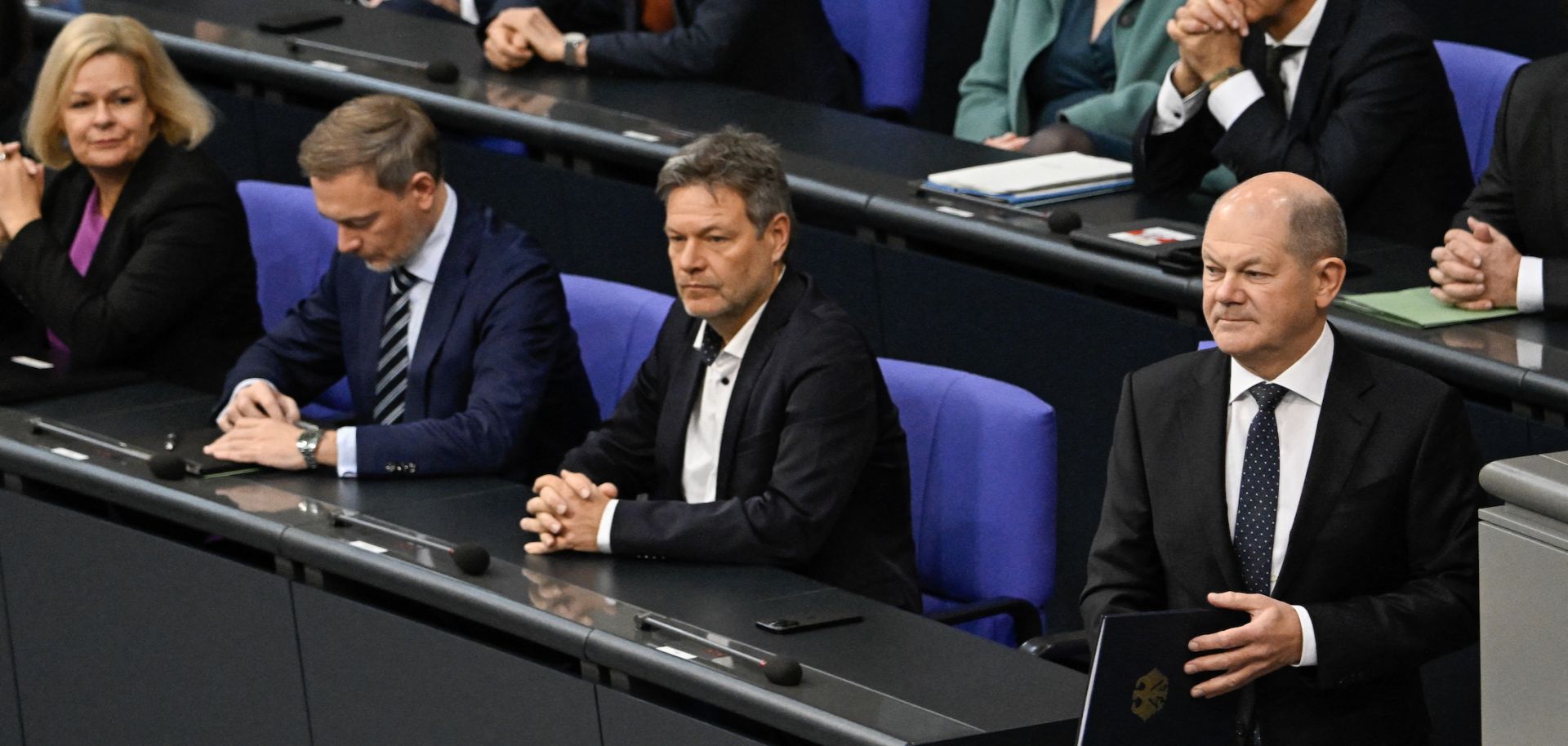 German Chancellor Olaf Scholz prepares to deliver a speech in parliament about the budget crisis on Nov. 28, 2023, as Interior Minister Nancy Faeser (left), Finance Minister Christian Lindner and Economy Minister Robert Habeck look on. 