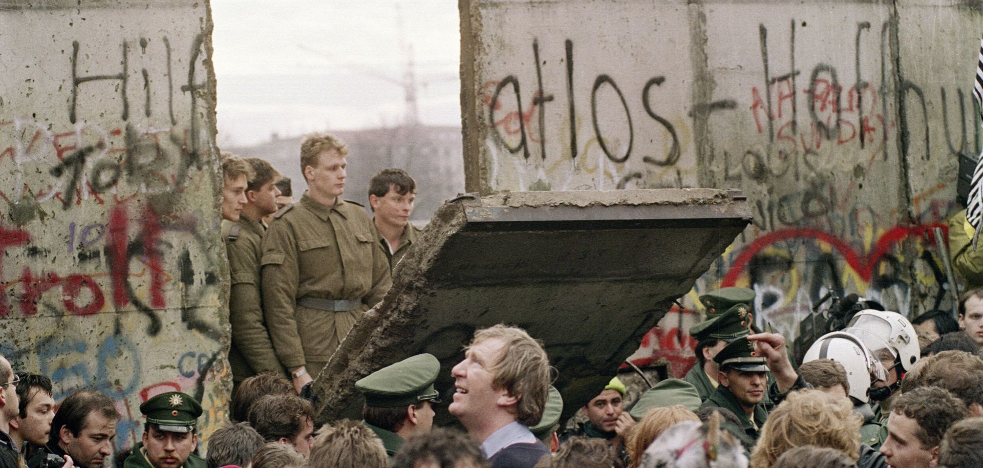 West Berliners crowd in front of the Berlin Wall on Nov. 11, 1989, as they watch East German border guards demolish a section of it.