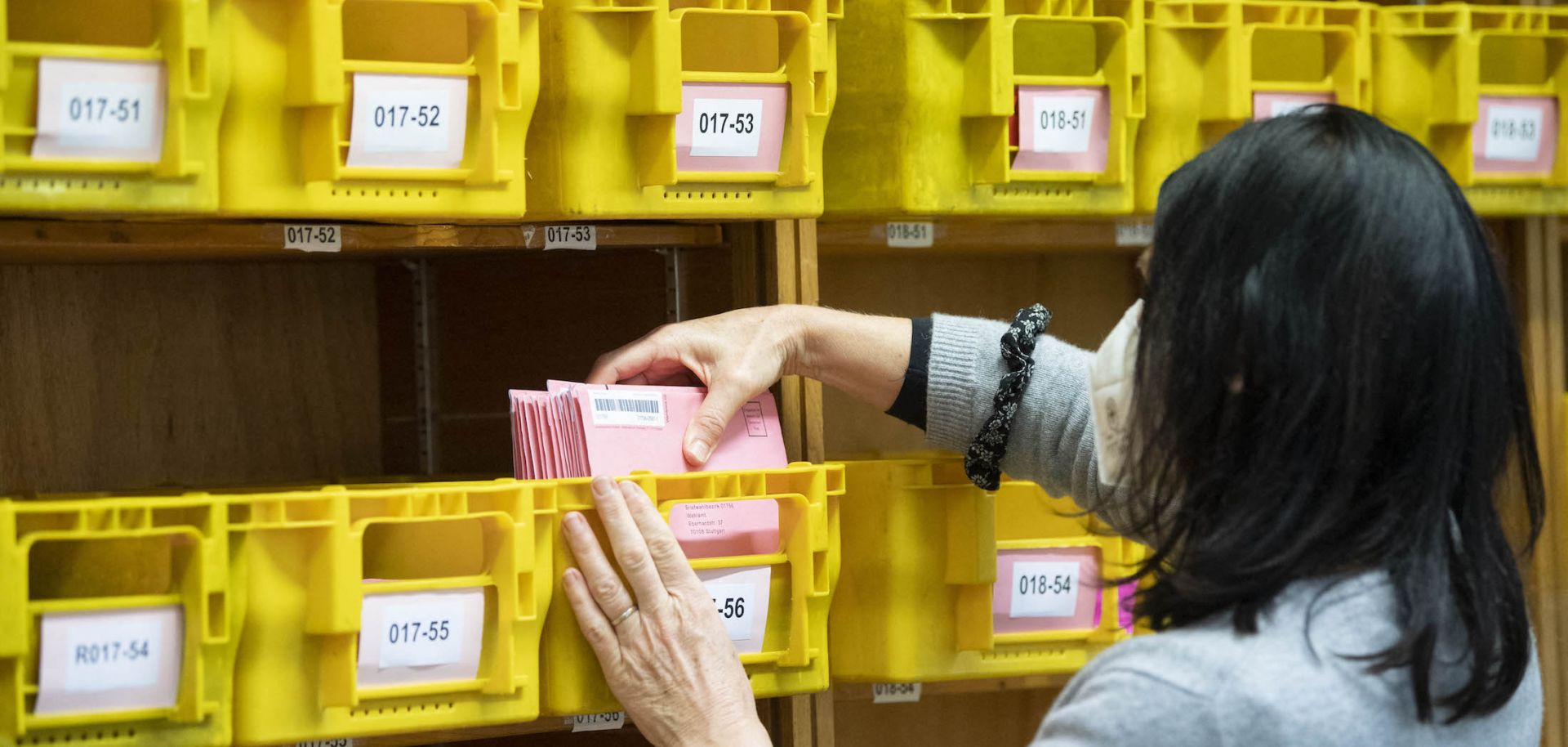 A staff member of the statistic office sorts postal voting envelopes by the numbers of the electoral districts on March 2, 2021, in Stuttgart, Baden-Wuerttemberg, Germany.