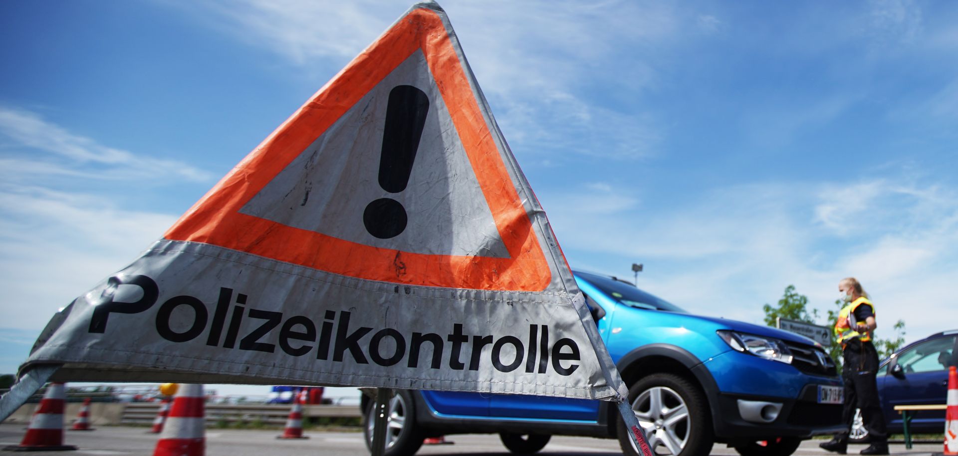 German border police officers stop cars at a checkpoint at the French border amid the COVID-19 crisis on May 8, 2020, near Rastatt, Germany.