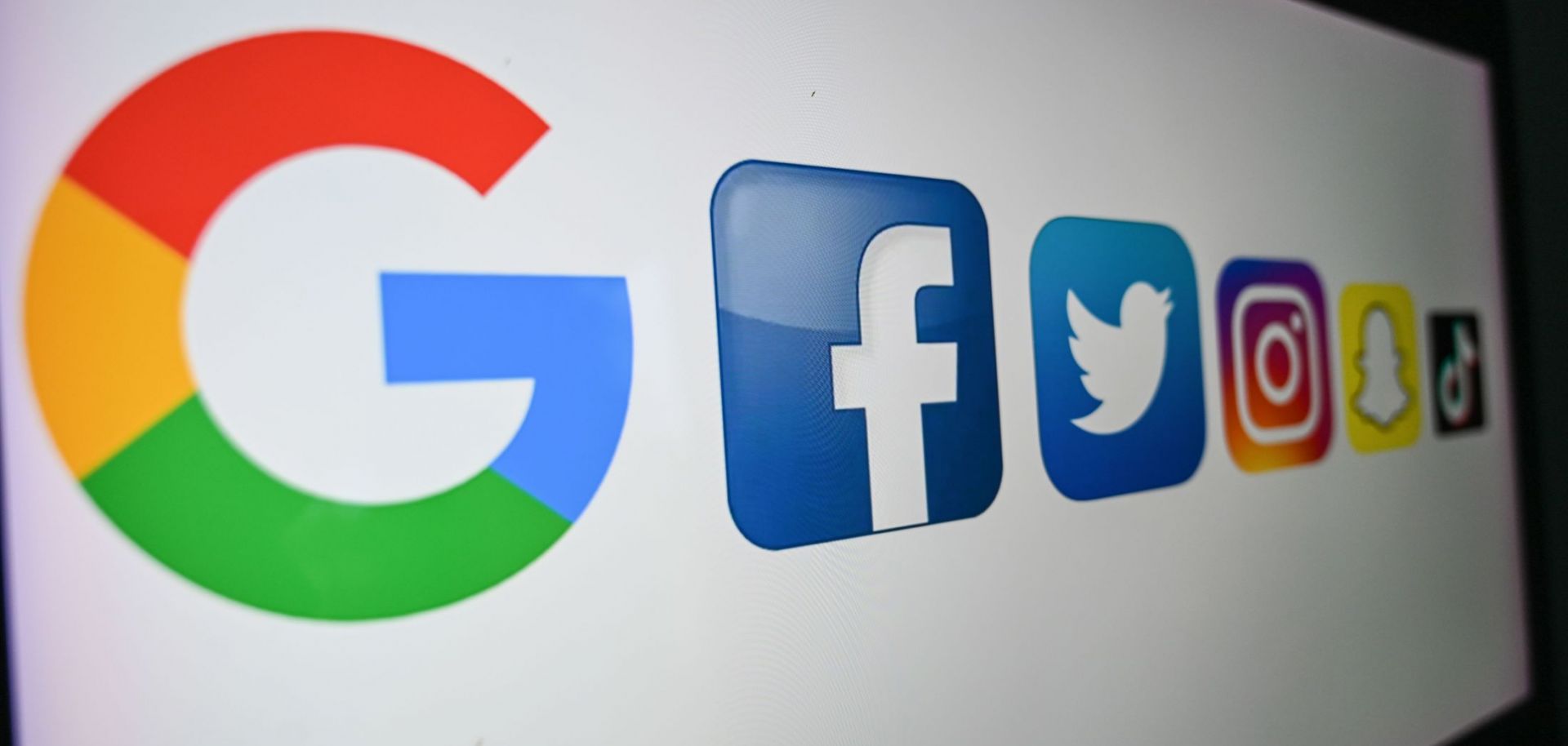 A photo taken on Oct. 21, 2020, shows the logos (left to right) of Google, Facebook, Twitter, Instagram, Snapchat and TikTok on a computer screen. 