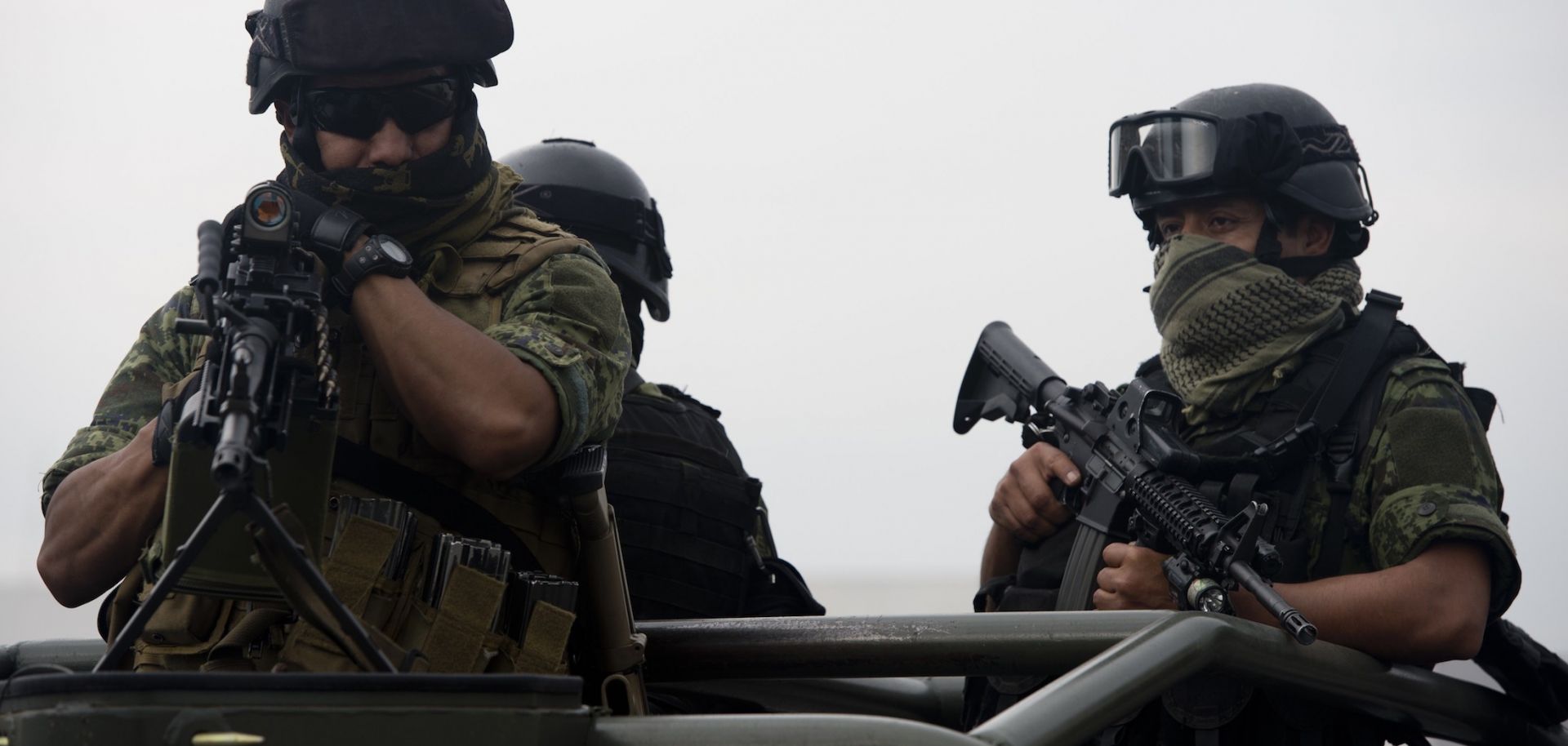 Soldiers stand guard as an alleged leader of the Gulf Cartel is presented to the media May 25, 2014, at the hangar of the Attorney General's office at Benito Juarez International Airport in Mexico City.