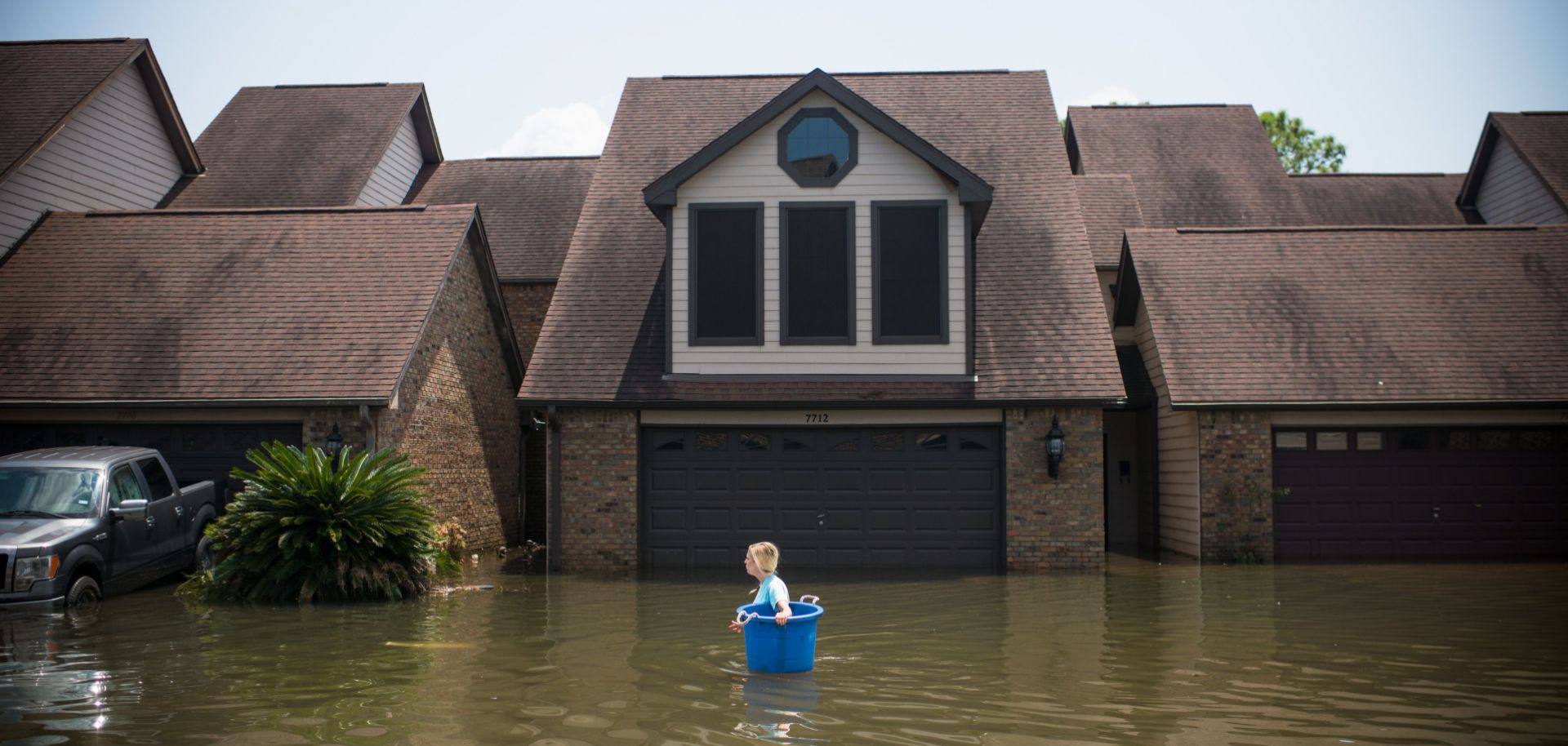 A woman tries to recover items from her flooded home in Port Arthur, Texas, in the wake of Hurricane Harvey. 