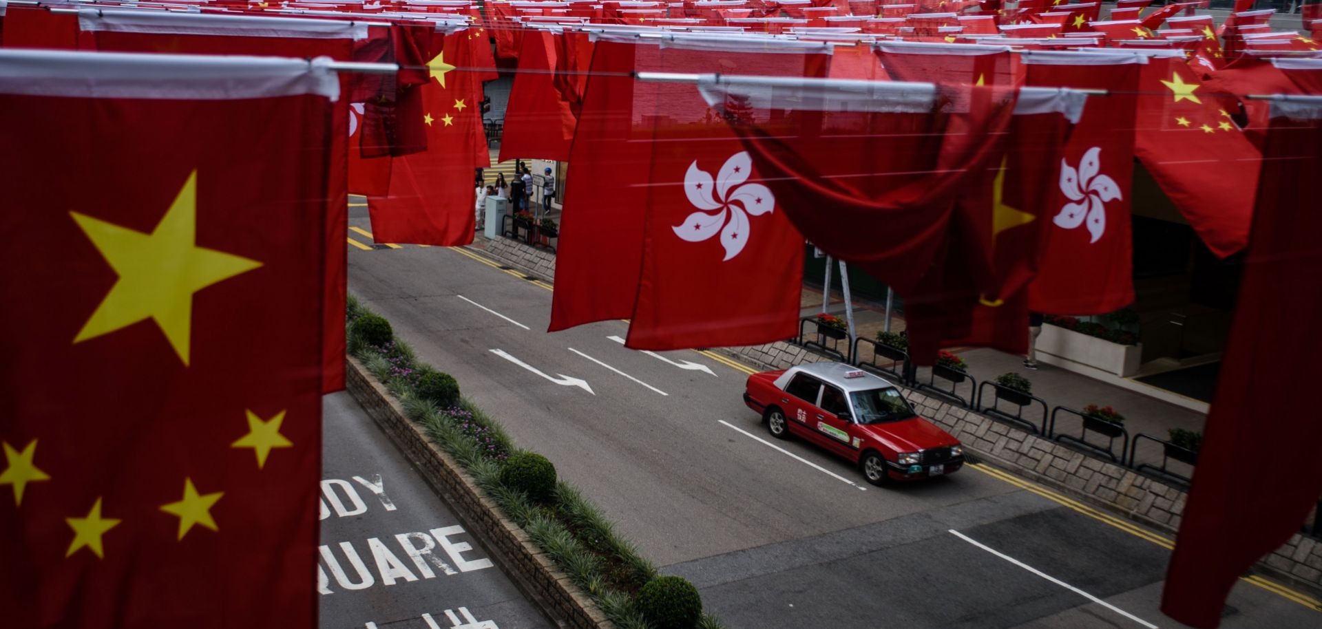 The national flags of China and Hong Kong hang above the street in anticipation of the 20-year anniversary of the handover of the city from the United Kingdom.