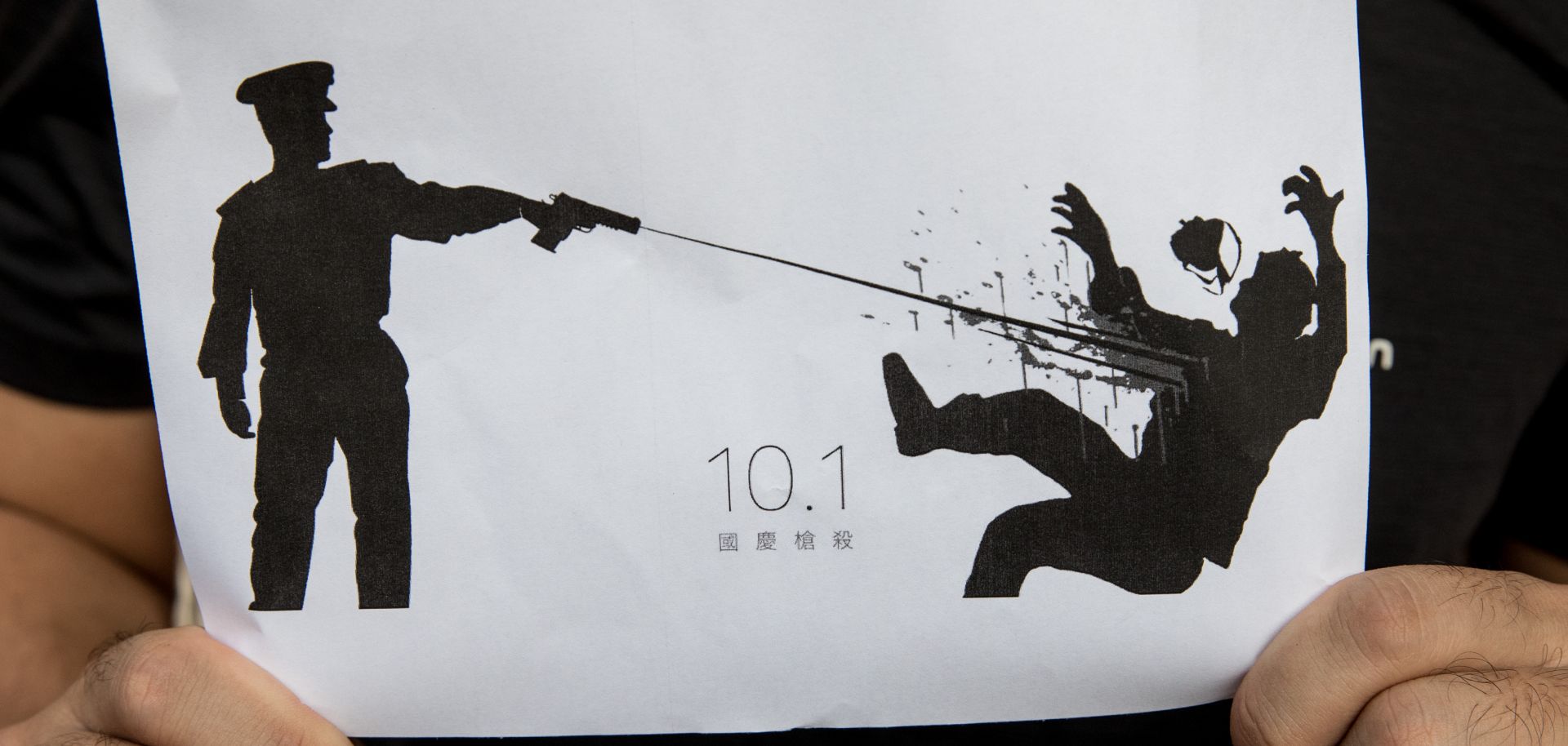 This photo shows a man in Hong Kong holding a drawing depicting the Oct. 1 shooting of a protester by a Hong Kong police officer.