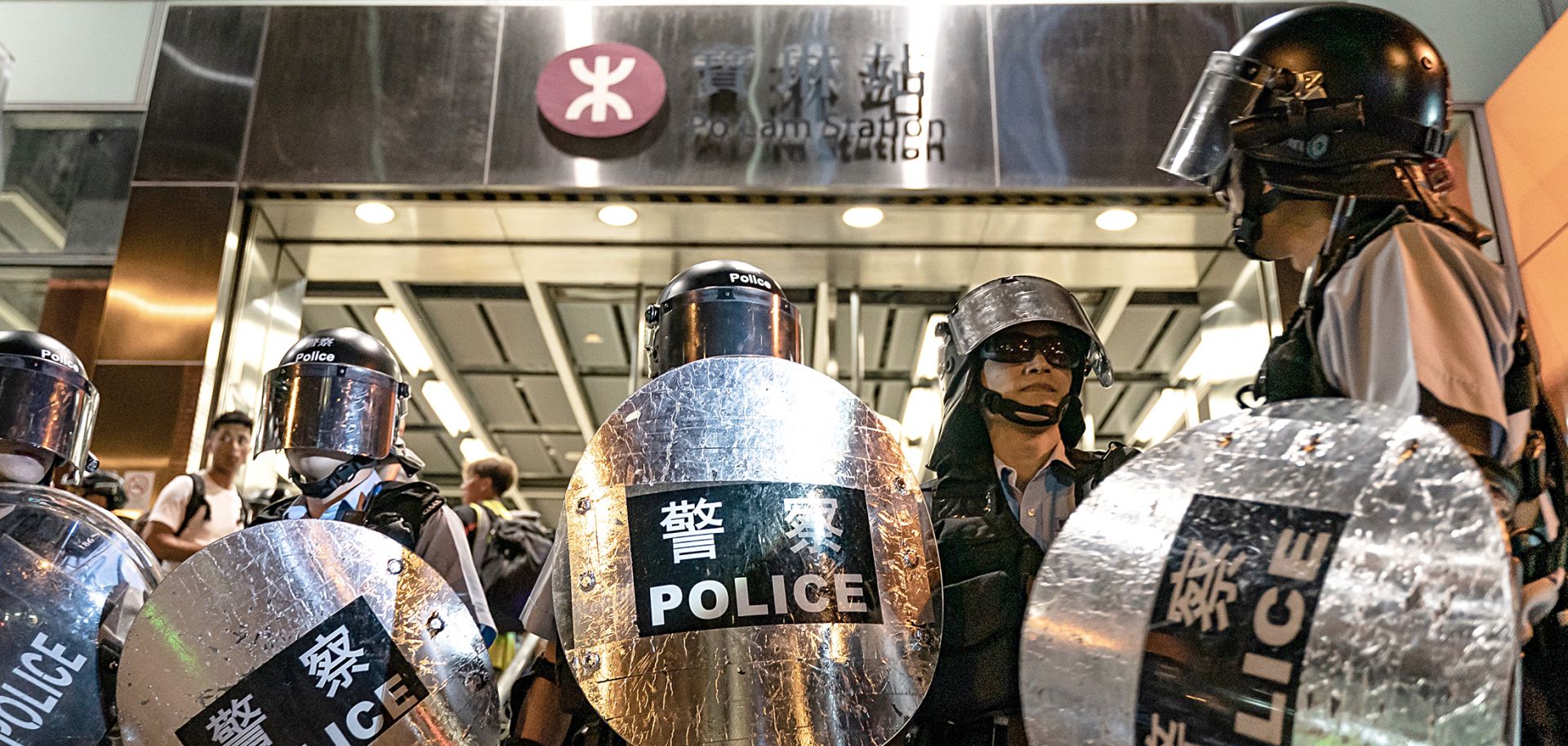 Police officers stand guard at Hong Kong's Po Lam Station during a standoff with protesters on Sept. 5, 2019.