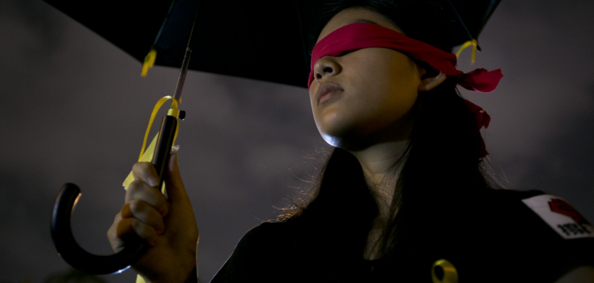 A student protester holds an umbrella with messages written on the fabric in front of Liberty Square to show support for Hong Kong pro-democracy rallies on Oct. 1, 2014, in Taipei, Taiwan.