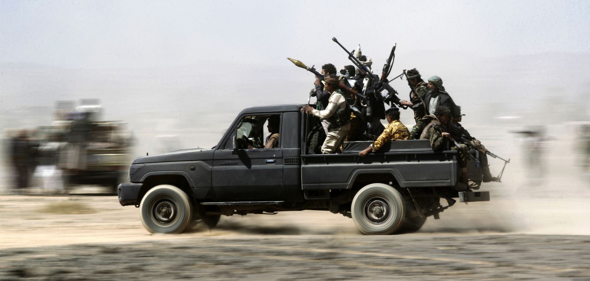 Tribesmen loyal to the Houthis ride in the back of a vehicle during a gathering to mobilize more fighters on Nov. 1, 2016, on the outskirts of Sanaa, Yemen.