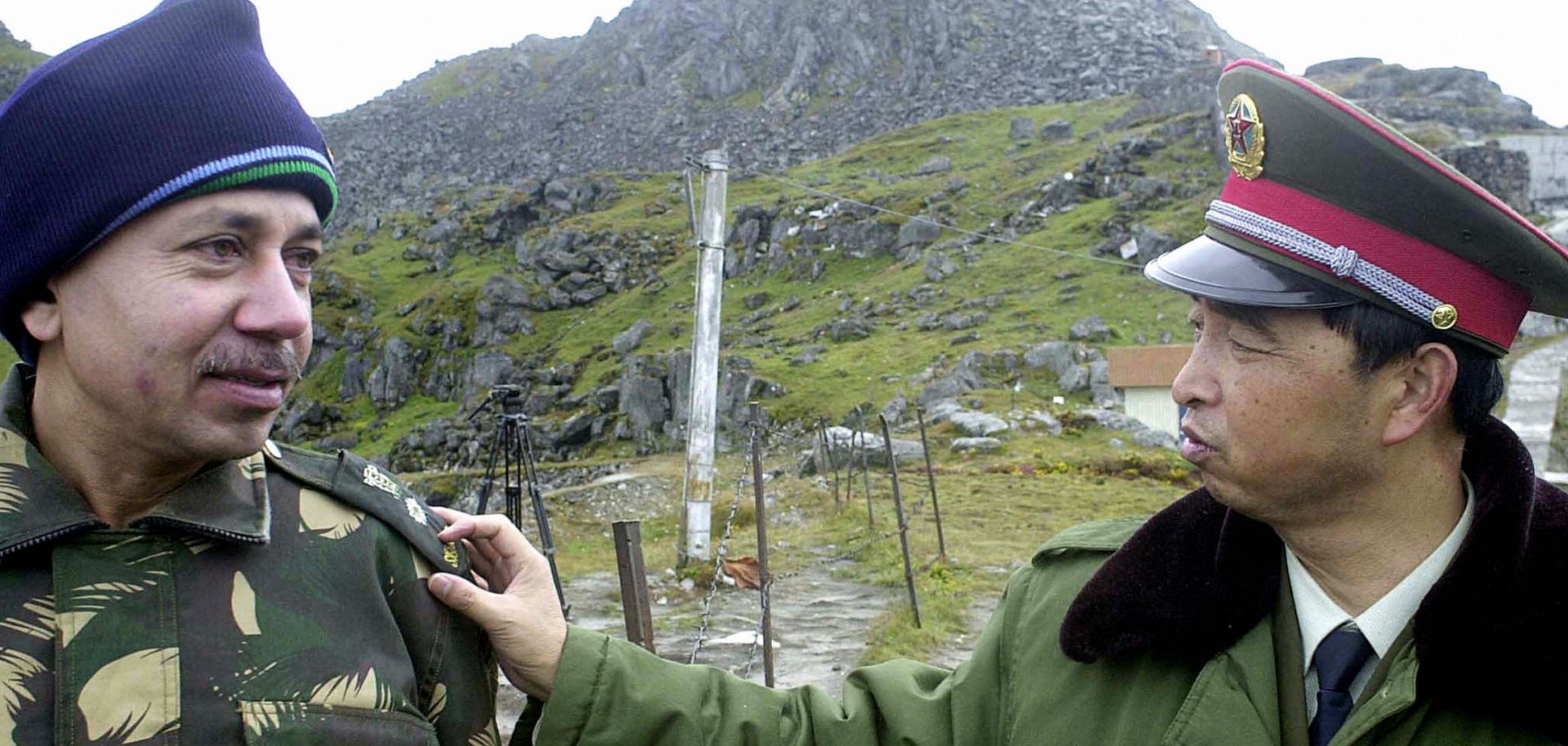 A Chinese soldier interacts with an Indian soldier at the Nathu La Pass area at the India-China border in the northeastern Indian state of Sikkim.