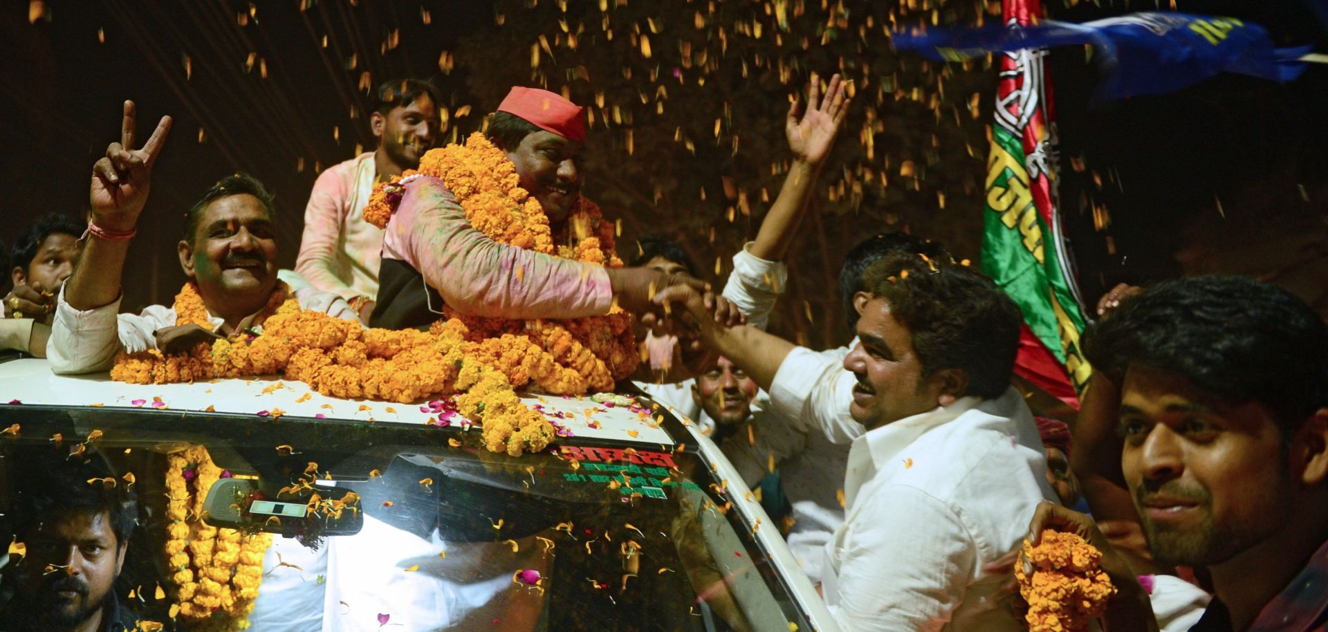 Samajwadi Party candidate Nagendra Pratap Singh Patel, center, celebrates with supporters in Allahabad after winning election to India's lower house of Parliament on March 14, 2018.