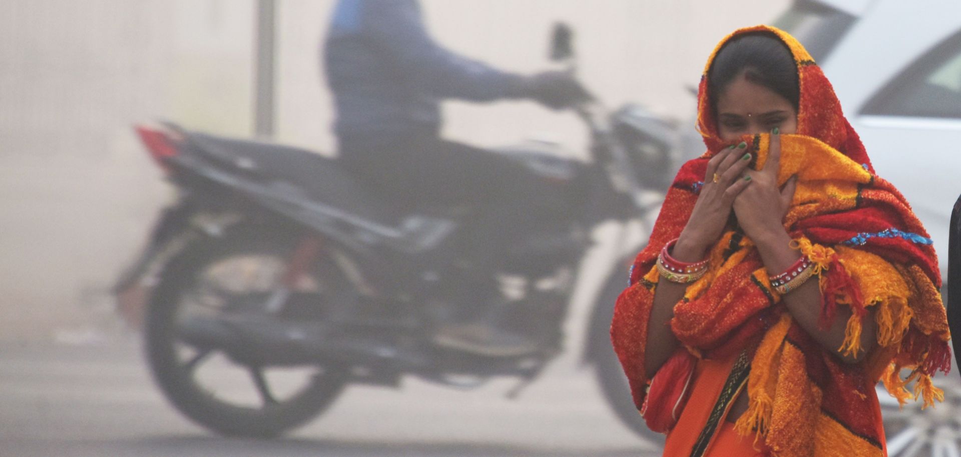 An Indian girl walks with her face covered amid heavy smog in New Delhi on Nov. 13.