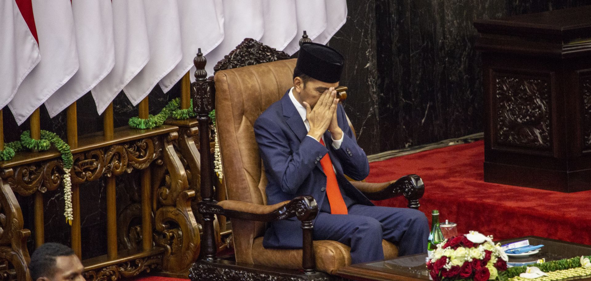 Indonesian President Joko "Jokowi" Widodo prays during his inauguration for his second term on Oct. 20, 2019, in Jakarta.