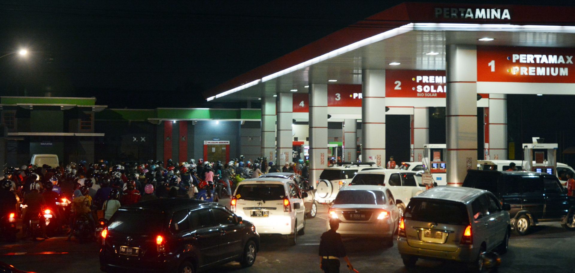 Cars and motorcycles line up at a fuel station in Purwokerto, on the island of Java, Indonesia, on Nov. 17, 2014.