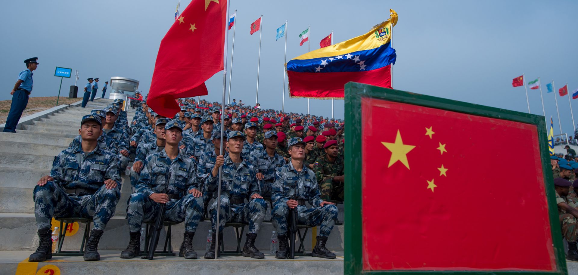 Venezuelan soldiers sit next to their Chinese counterparts during the opening ceremonies for the portion of the International Army Games held in China's Hubei province.