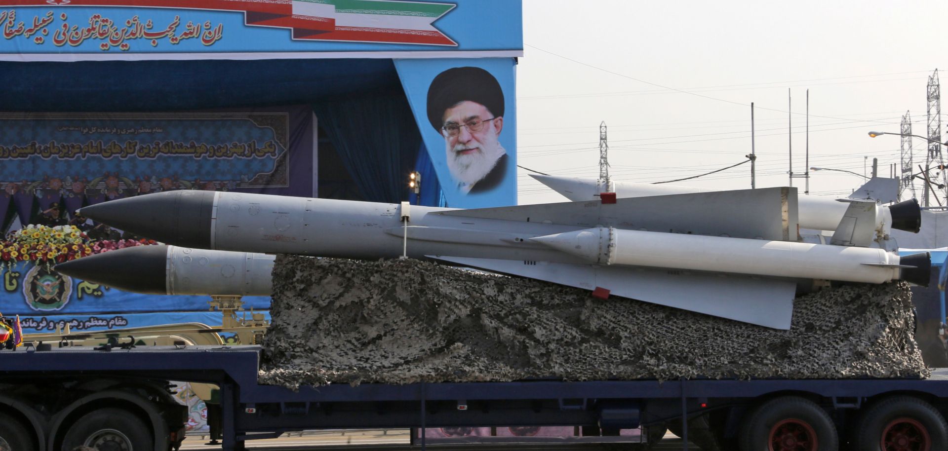 An Iranian military truck carries surface-to-air missiles past a portrait of Iran's Supreme Leader Ayatollah Ali Khamenei during a military parade in Tehran.