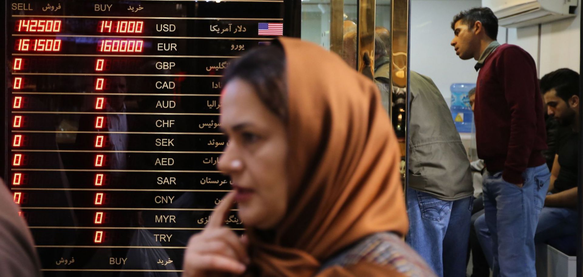 A woman walks past a currency exchange shop in the grand bazaar in Tehran, the capital of Iran, on Nov. 3, 2018.