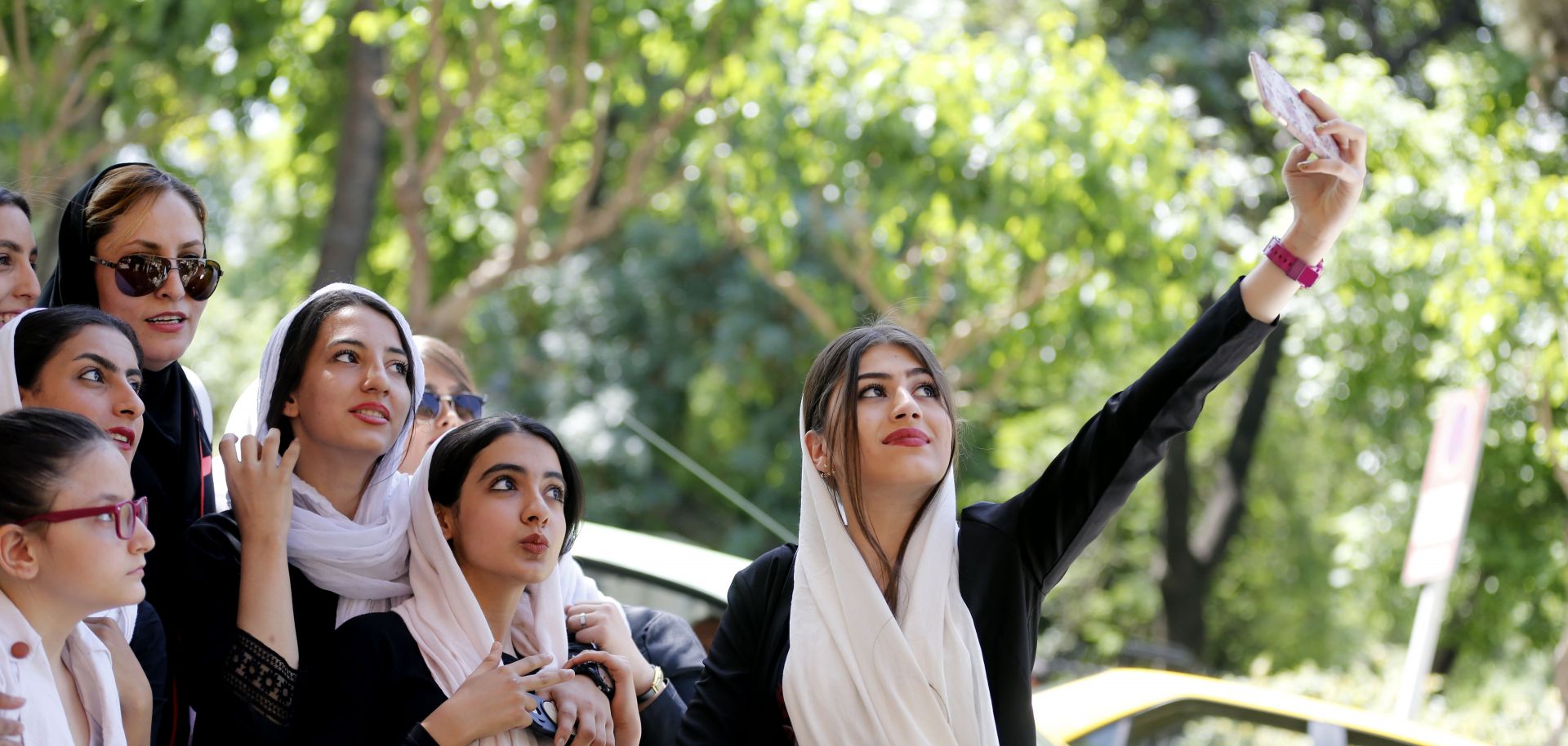Women pose for a photo while showing their support for Tehran's mayor at a rally in May 2017.