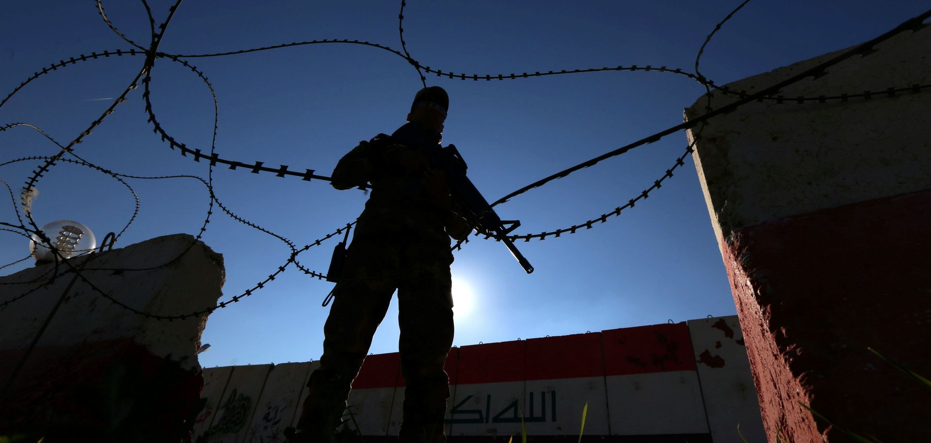 An Iraqi soldier stands guard north of Baghdad in Nineveh as the Iraqi army prepares to push north toward Mosul. 