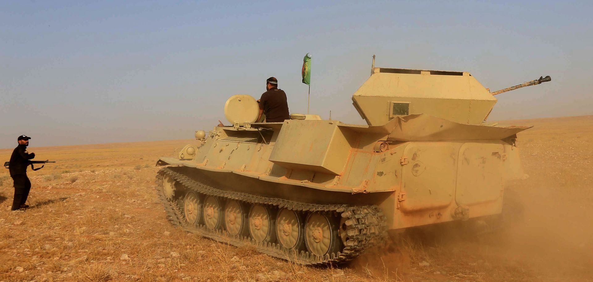 An infantry fighting vehicle belonging to one of Iraq's popular mobilization units maneuvers in the desert near Anbar province on Sept. 16, 2019.