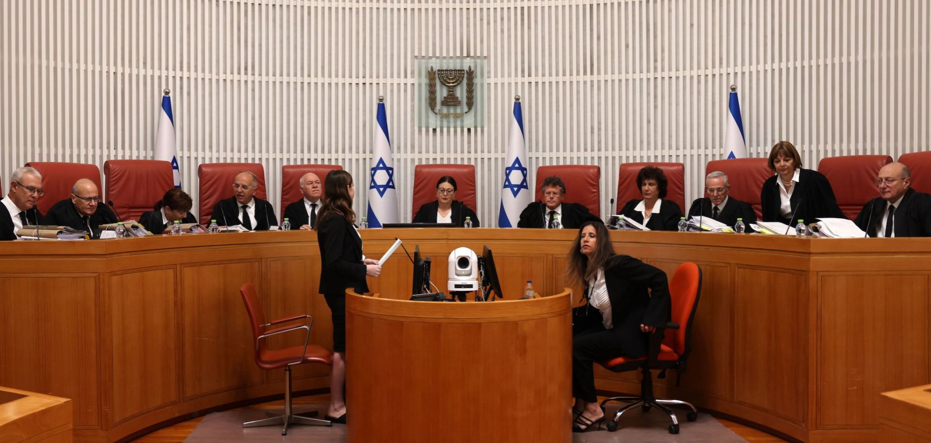 The president of Israel's Supreme Court, Esther Hayut (center), and judges assemble on Sept. 28, 2023, to hear petitions against a law that blocks the court from potentially ordering the prime minister to recuse himself from office. 