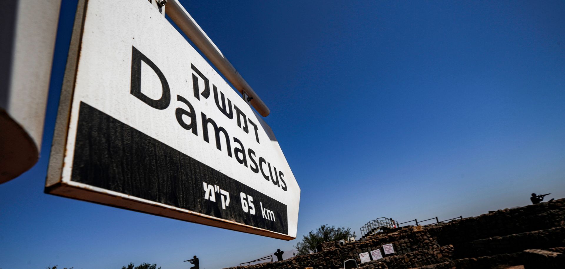 This picture taken on Aug. 25, 2019, from a tourist lookout point at an Israeli army outpost on Mount Bental in the Israeli-annexed Golan Heights shows a directional sign for Damascus.