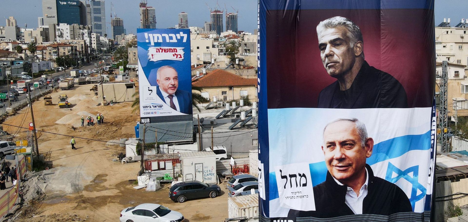Campaign posters hang over a construction site in Bnei Brak, Israel, on March 14, 2021.