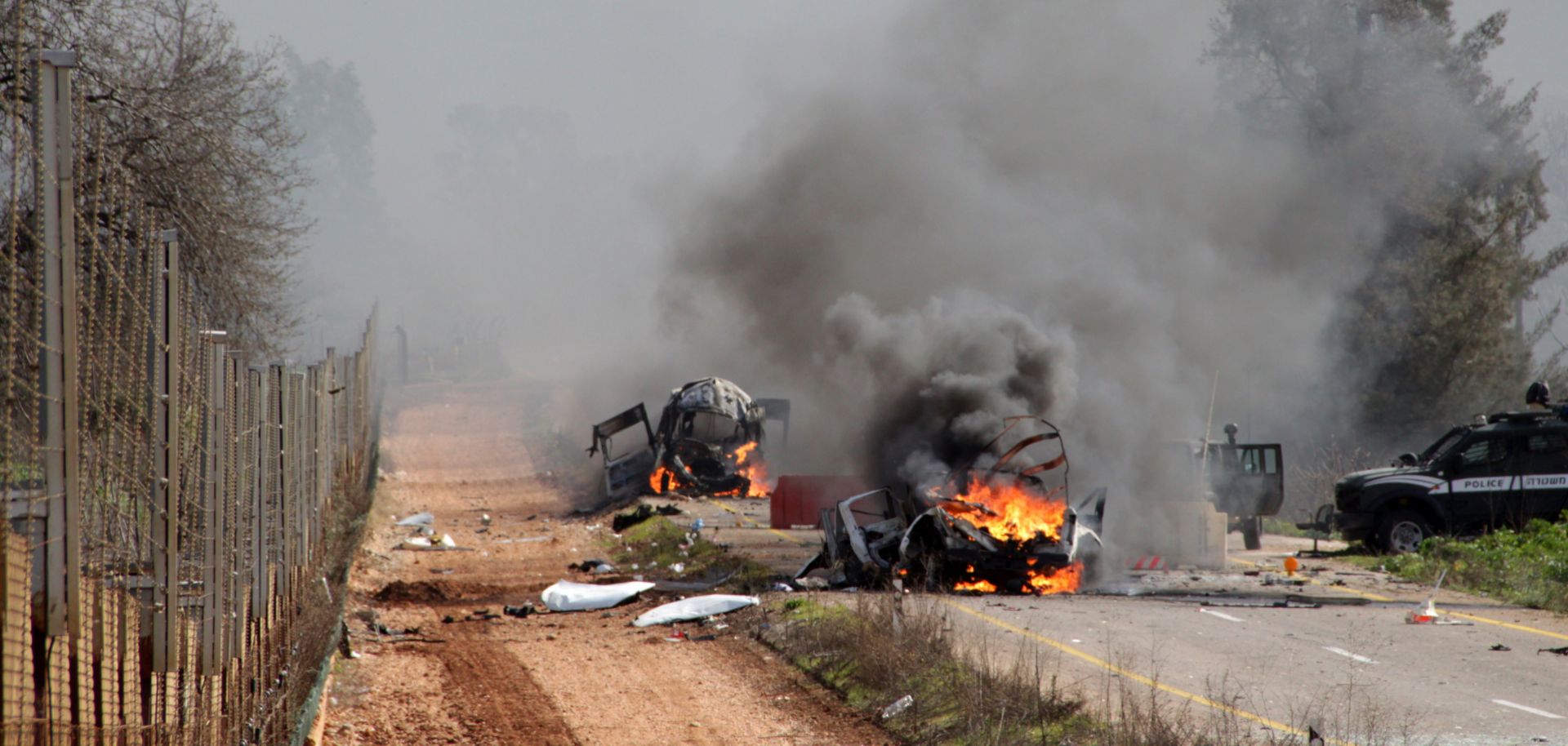 Israeli military vehicles burn after a Hezbollah missile attack in the disputed Shebaa Farms area of southern Lebanon on Jan. 28, 2015. The attack killed two Israeli soldiers and prompted an Israeli military response.