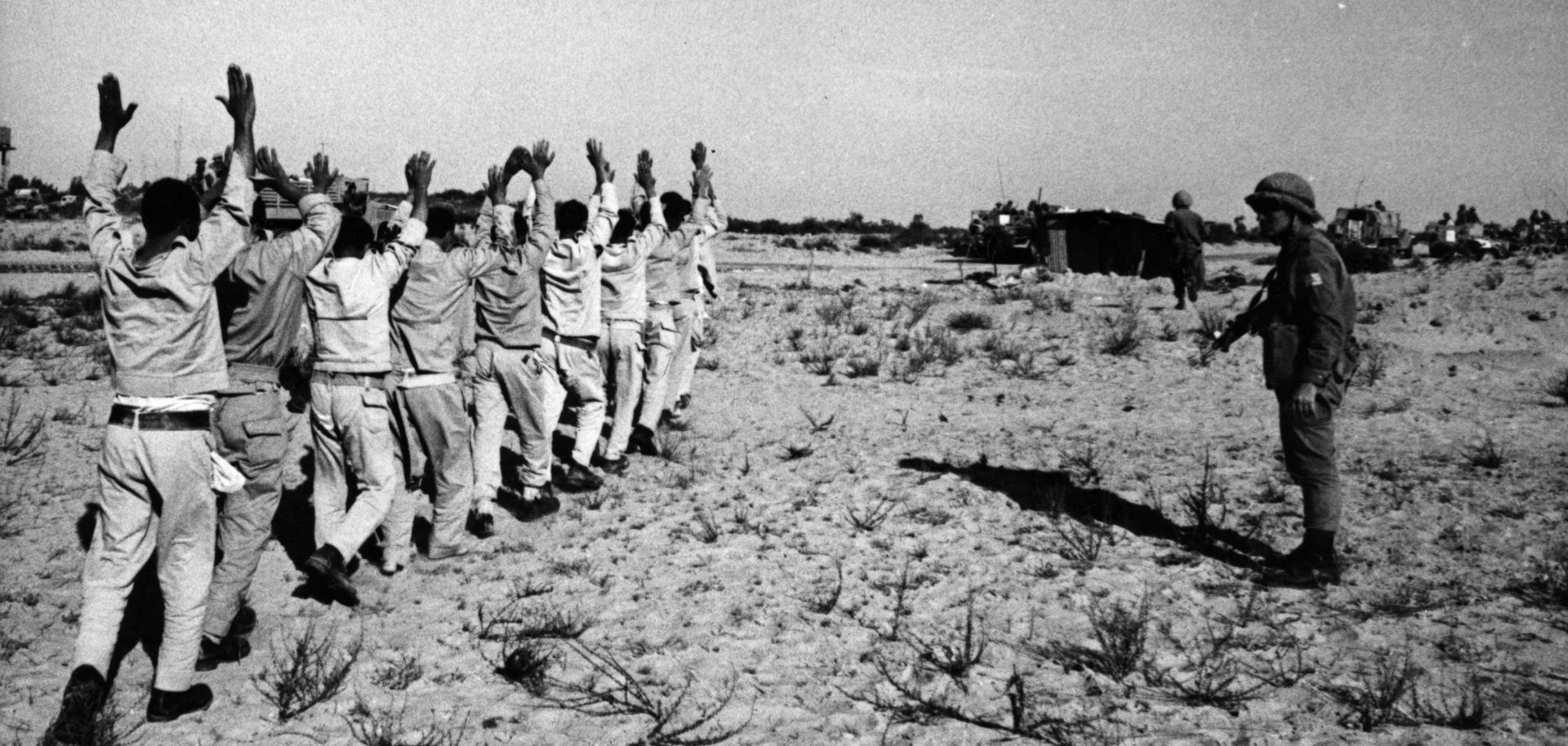 Egyptian prisoners of war holding their hands aloft after being rounded up by Israeli forces in the Sinai Desert following the Six-Day War in 1967.