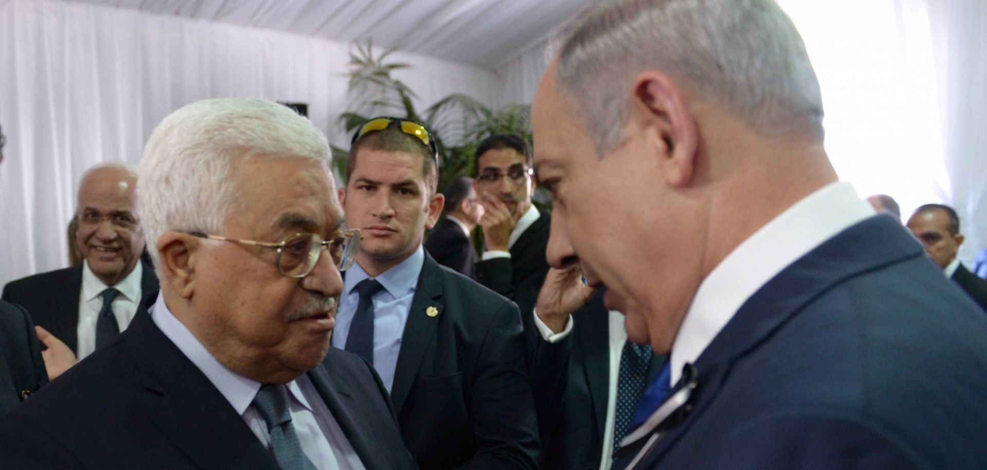 Israeli Prime Minister Benjamin Netanyahu shakes hands with Palestinian Authority President Mahmoud Abbas.