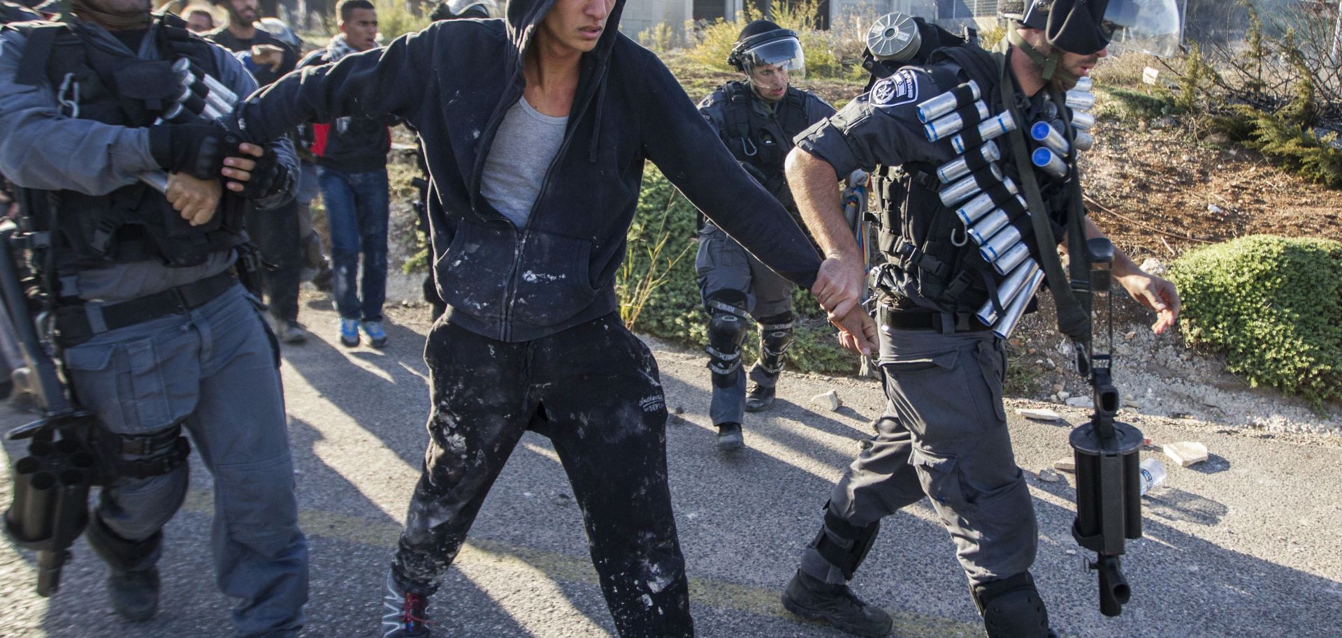 Israeli security forces detain an Arab-Israeli youth during clashes.