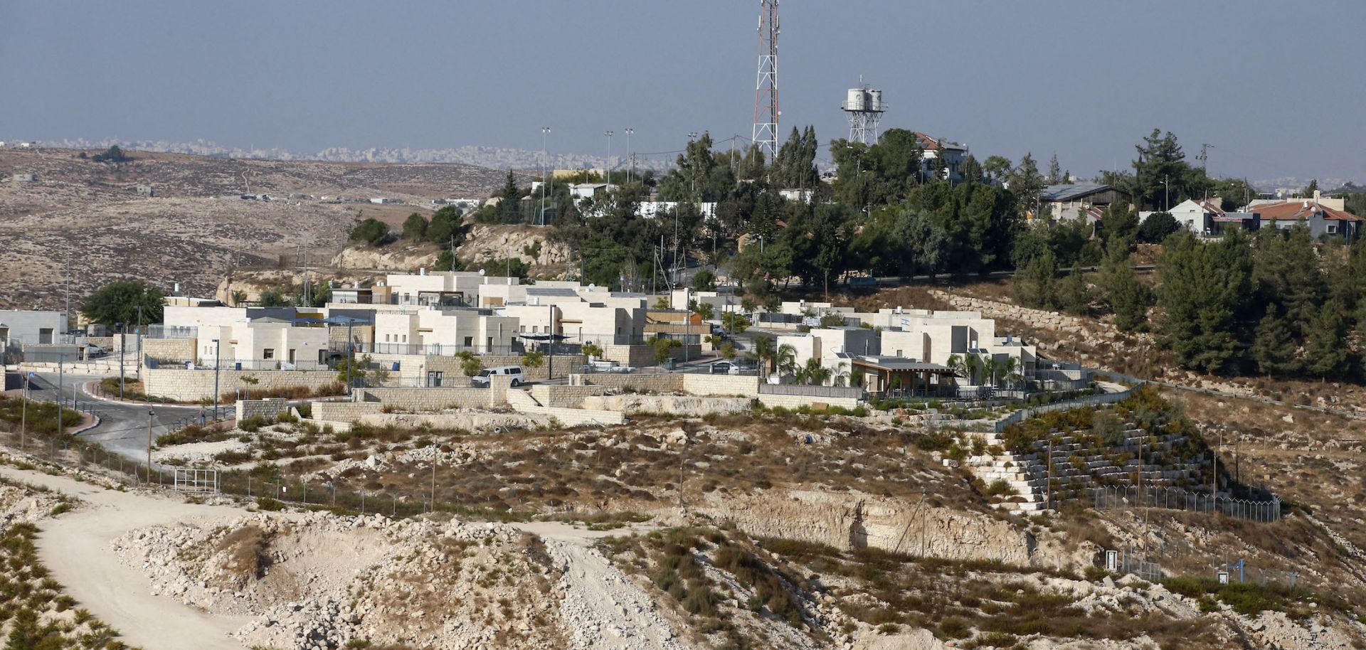 A picture taken on October 14, 2020, shows the Israeli Shimaa settlement south of the city of Hebron in the occupied West Bank, with the Palestinian village of Samua in the background. 