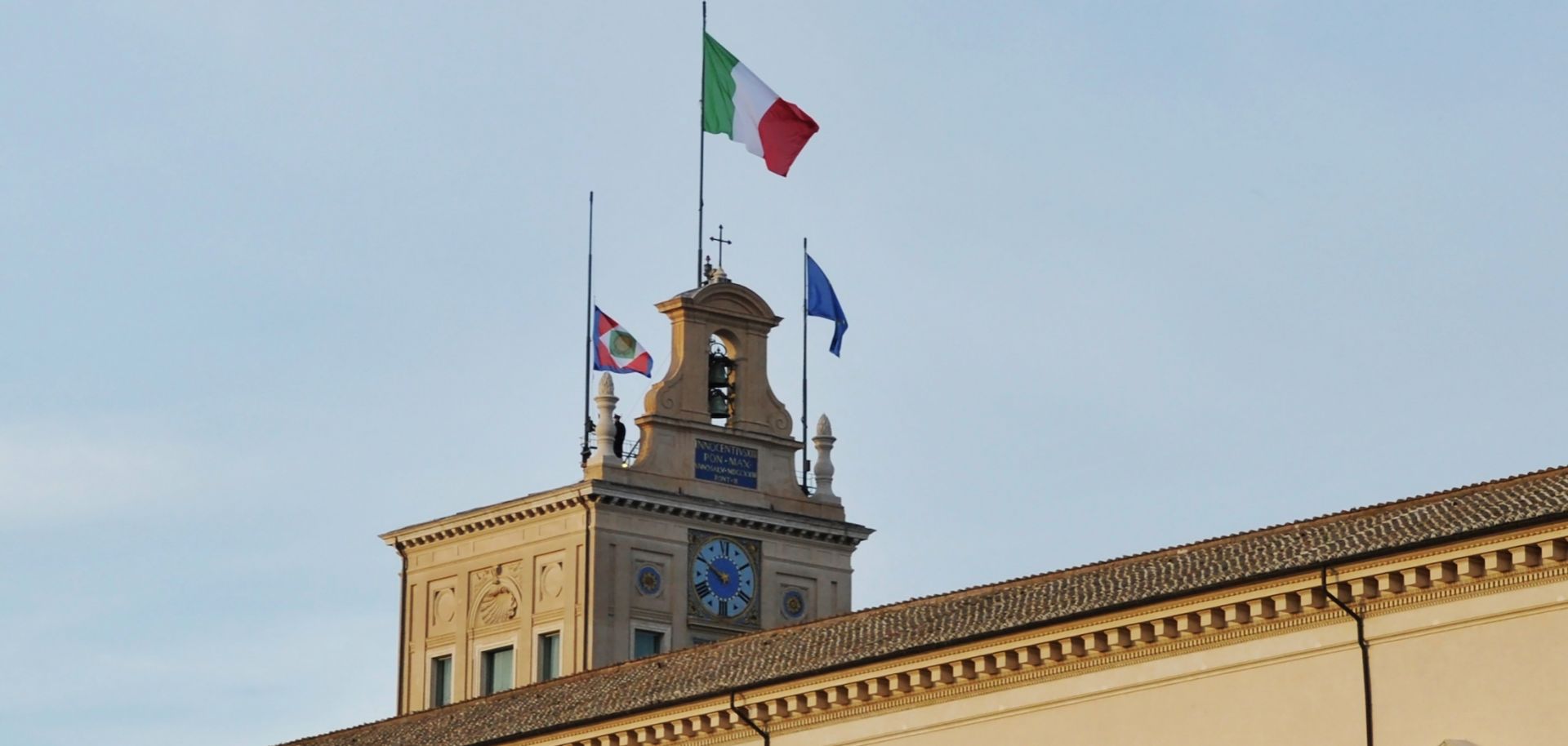A photo taken on Feb. 3, 2022, shows flags raised outside the Quirinale in Rome, Italy, for the arrival of newly re-elected Italian President Sergio Mattarella.