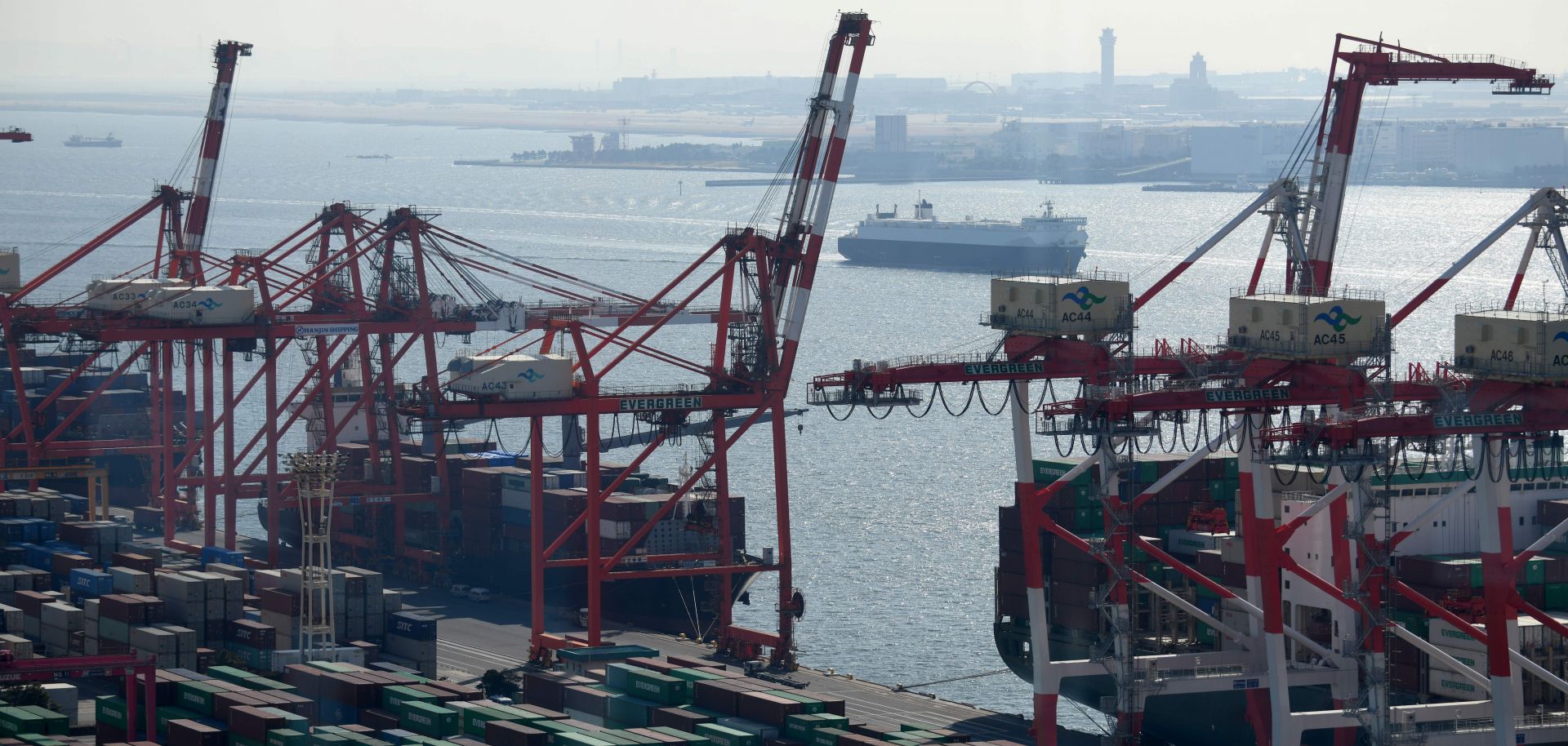 Cranes unload containers from ships at the international container yard in Tokyo's port on Jan. 23, 2019.