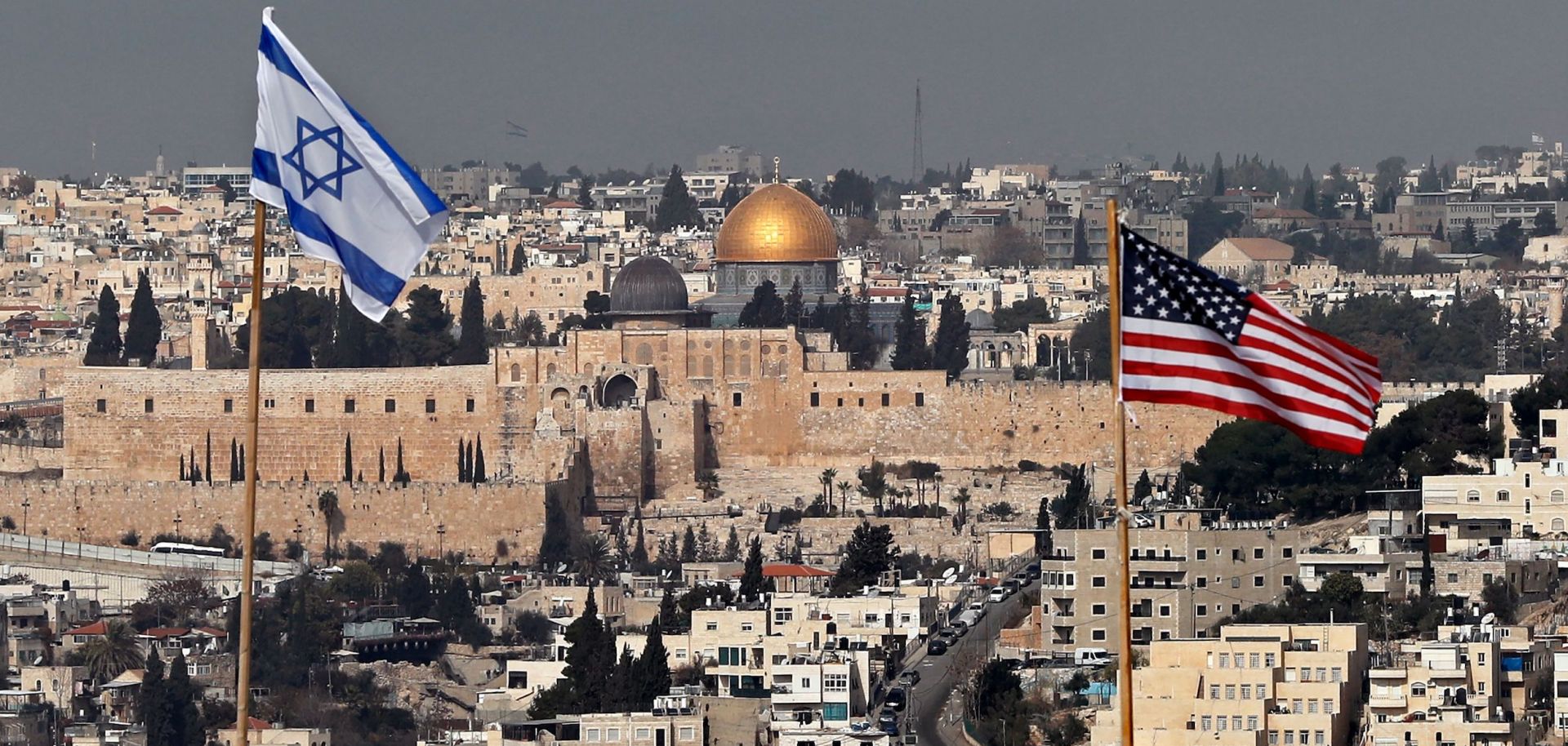 The Israeli and U.S. flags fly from the roof of an Israeli settlement building in East Jerusalem on Dec. 13, 2017.