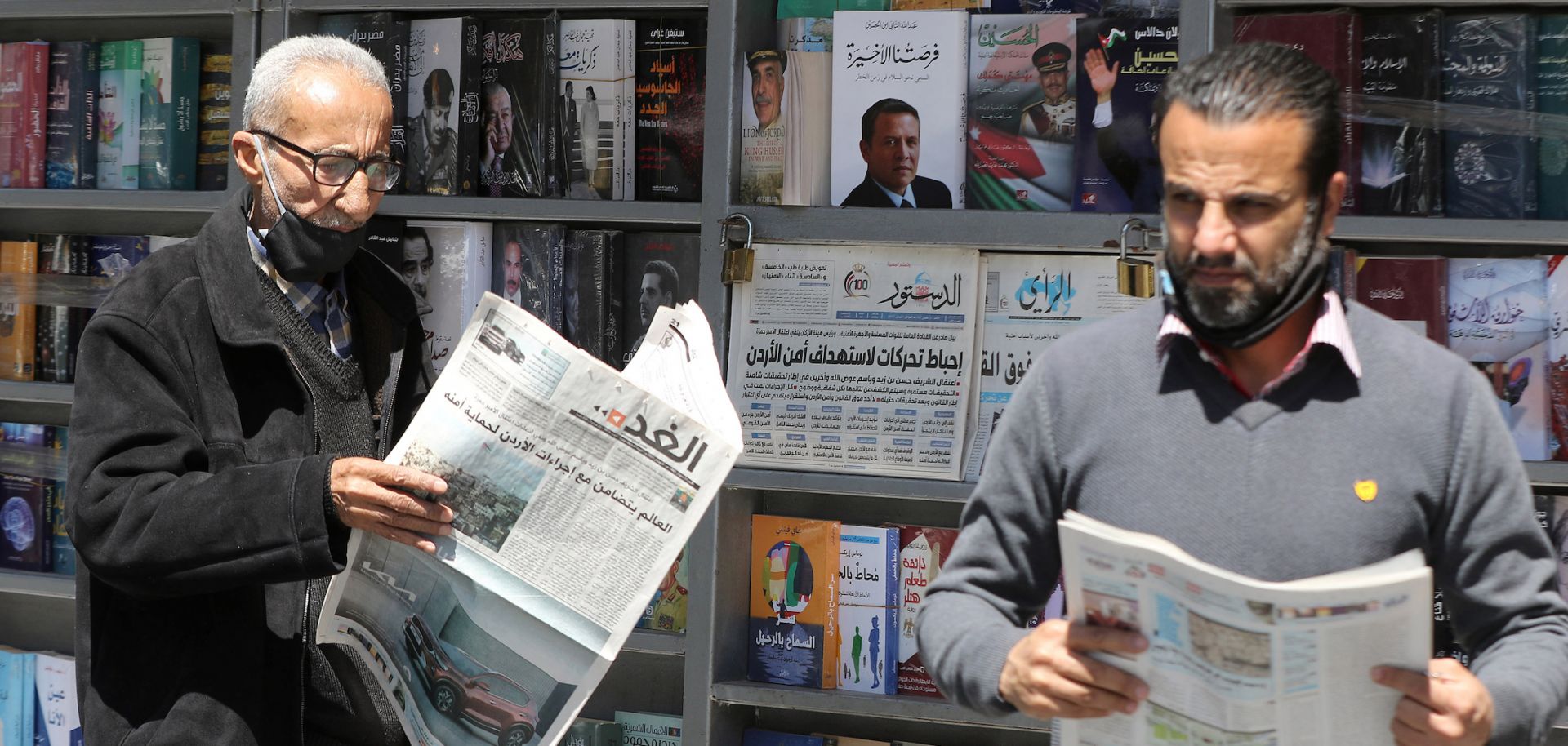 Men read local newspapers in Amman, Jordan, on April 4, 2021.