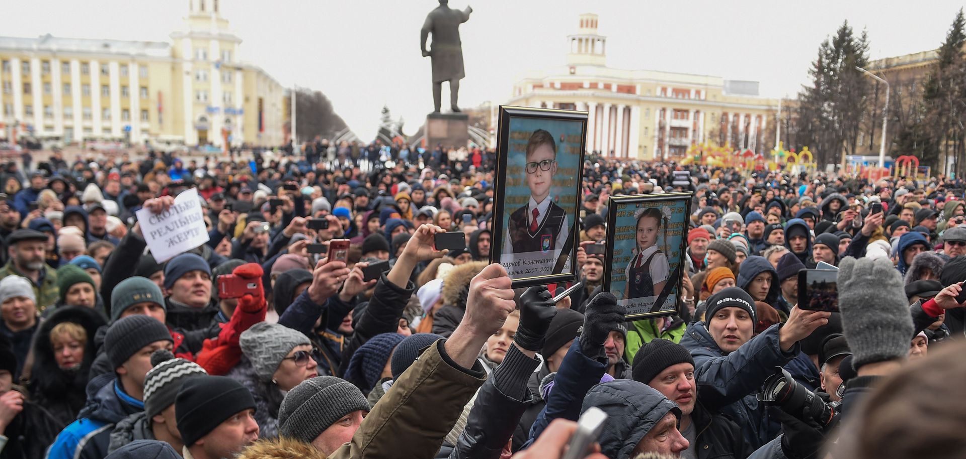 People gather to pay tribute to the victims of the March 25 fire at a shopping center in Kemerovo.