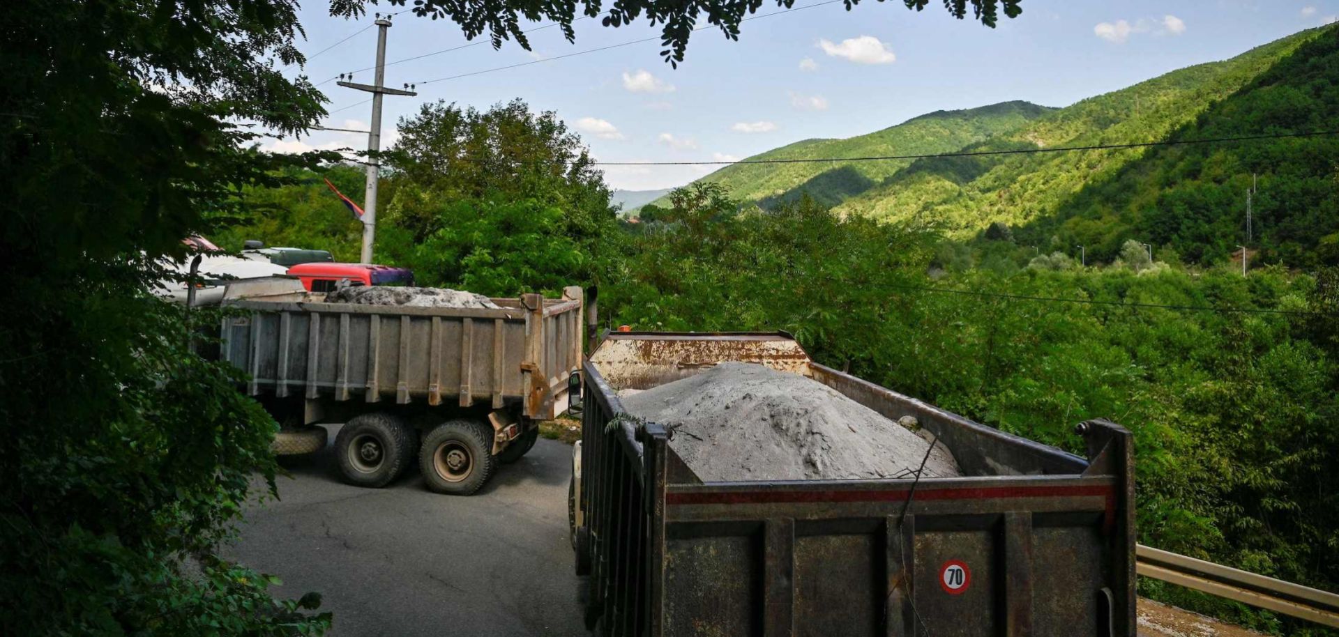 Trucks loaded with sand form a barricade in a road near the Kosovar town of Zubin Potok on Aug. 1.